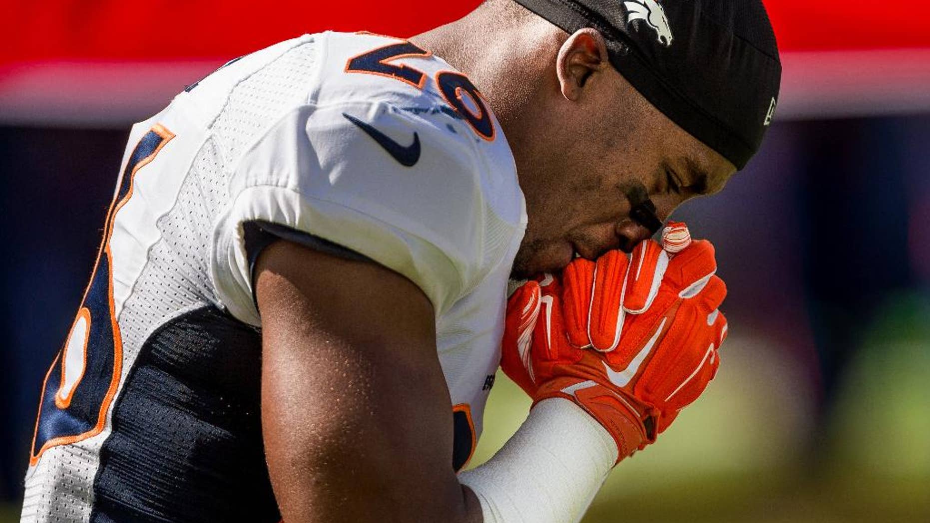 Denver Broncos player Rahim Moore kneels into the end zone to pray before a game against the Seattle Seahawks Sunday, Sept. 21, 2014, in Seattle. (AP Photo/seattlepi.com, Jordan Stead) MAGS OUT; NO SALES; SEATTLE TIMES OUT; TV OUT; MANDATORY CREDIT