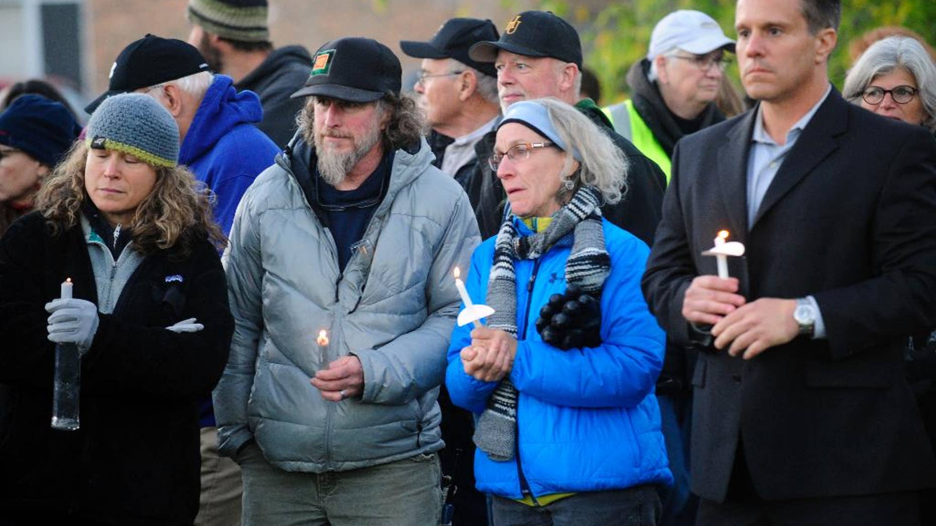 Mourners hold candles Monday, Oct. 10, 2016, during a candlelight vigil attended by abut 1,000 at Harwood Union High School in Duxbury, Vt., for the teenaged victims killed in Saturday night's crash on Interstate 89 in Williston. Four of the five teens killed by the wrong-way driver were students at Harwood. The fifth student killed was from Fayston and attended a private school in New Hampshire. (Stefan Hard/Times Argus via AP)