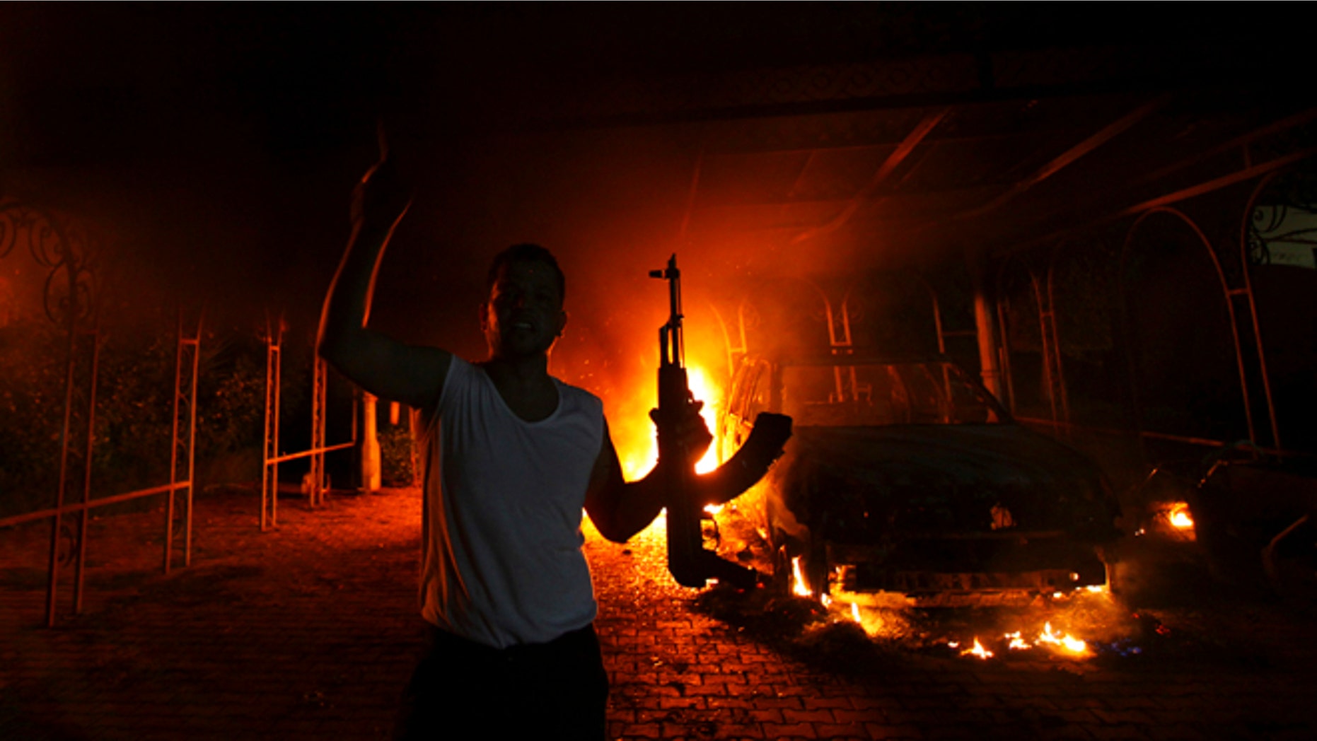 Sept. 11, 2012: A protester reacts as the U.S. Consulate in Benghazi is seen in flames.