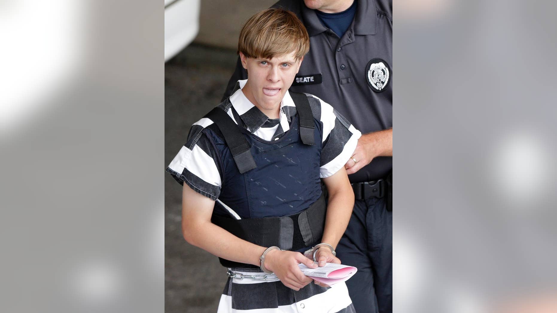 FILE - In this Thursday, June 18, 2015, file photo, Charleston, S.C., shooting suspect Dylann Roof is escorted from the Cleveland County Courthouse in Shelby, N.C. The first jurors report to the federal courthouse in Charleston, S.C., on Monday, Sept. 26, 2016 for jury screening in the federal death penalty case charging Roof with hate crimes and other charges. He is charged in the June, 17, 2015 slayings of nine people during a Bible study at Emanuel AME Church in Charleston. (AP Photo/Chuck Burton, File)