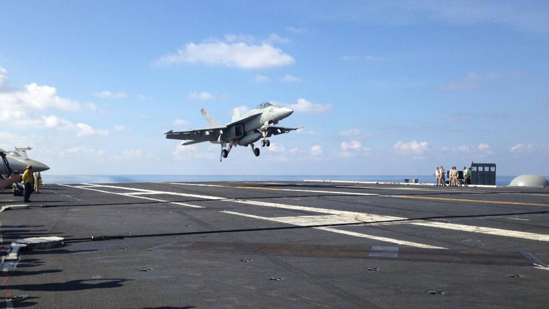 An FA-18 jet fighter takes off on the USS John C. Stennis, aircraft carrier in the South China Sea on Friday, April 15, 2016. U.S. Defense Secretary Ash Carter visited the aircraft carrier during a trip to the region. (AP Photo/Lolita C. Baldor)