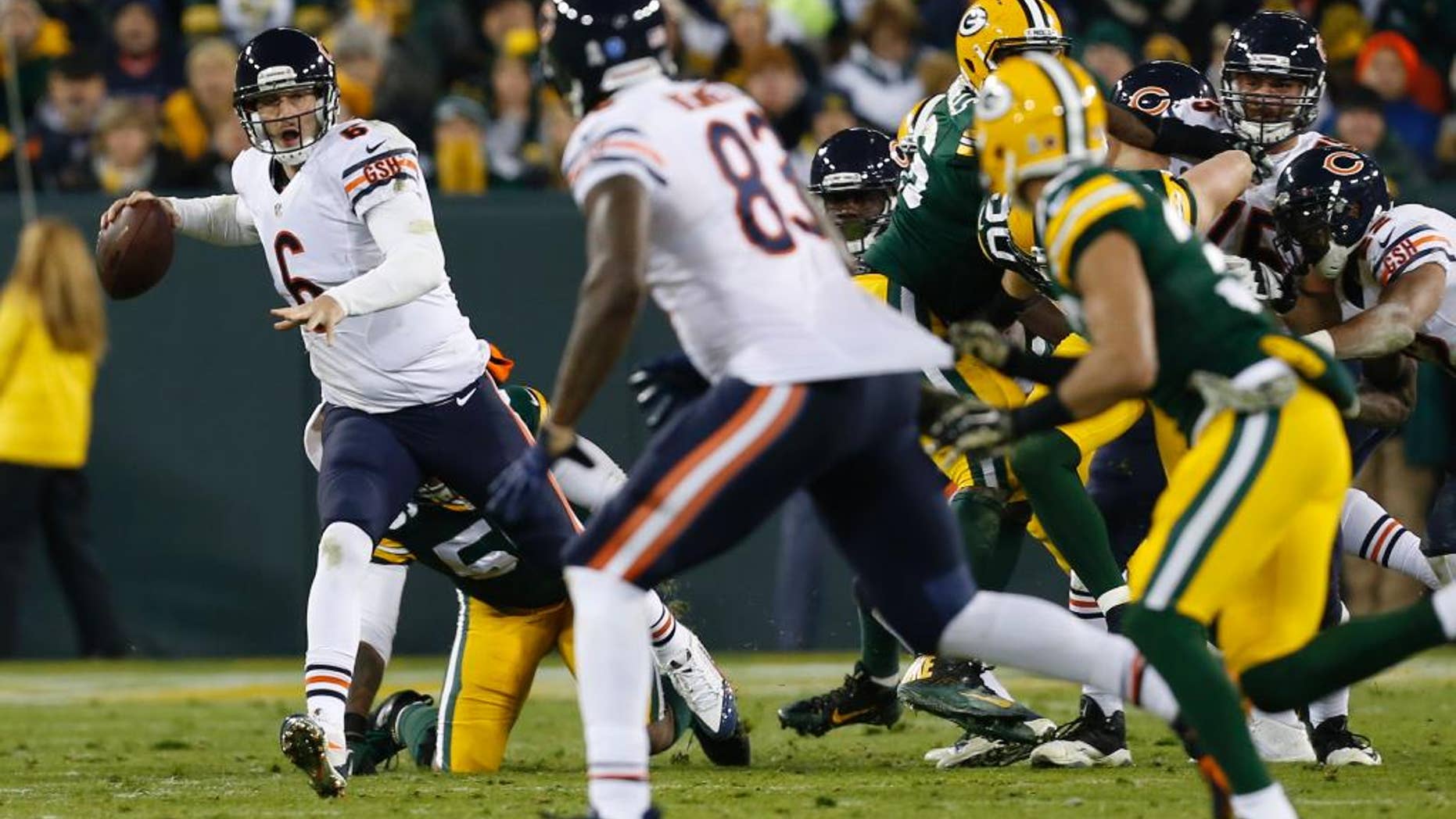 Chicago Bears quarterback Jay Cutler (6) looks to throw a pass to tight end Martellus Bennett (83) during the second half of an NFL football game against the Green Bay Packers Sunday, Nov. 9, 2014, in Green Bay, Wis. The pass in this play was incomplete. (AP Photo/Mike Roemer)