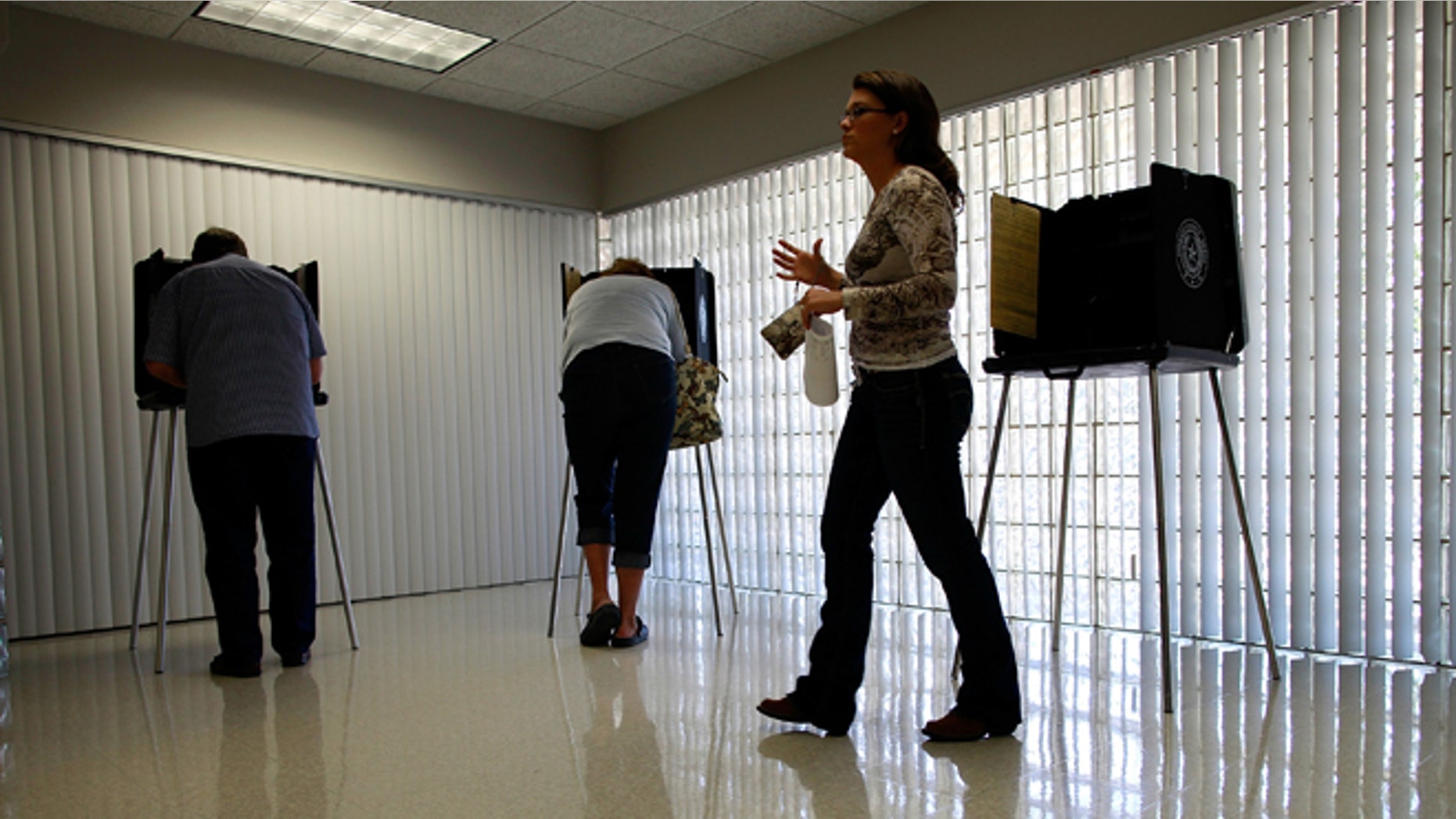 MANSFIELD, TX - NOVEMBER 06: Voters cast their ballots on November 6, 2012 in Mansfield, Texas. Americans across the country participate in Election Day as President Barack Obama and Republican nominee former Massachusetts Gov. Mitt Romney remain in a virtual tie in the national exit polls. (Photo by Tom Pennington/Getty Images)