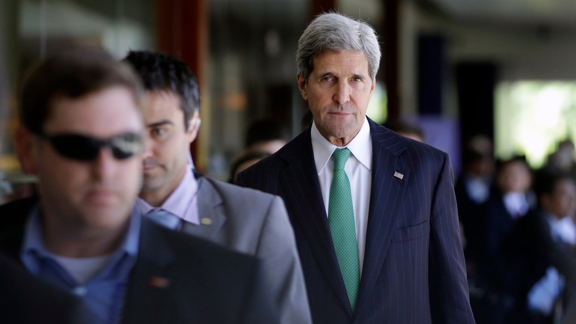 U.S. State Secretary John Kerry walks with other delegate members during the Asia-Pacific Economic Cooperation (APEC) ministerial meeting in Bali, Indonesia, Saturday, Oct. 5, 2013. Kerry says talks on a trans-Pacific trade pact are forging ahead despite President Barack Obama's absence due to the government shutdown. (AP Photo/Dita Alangkara)