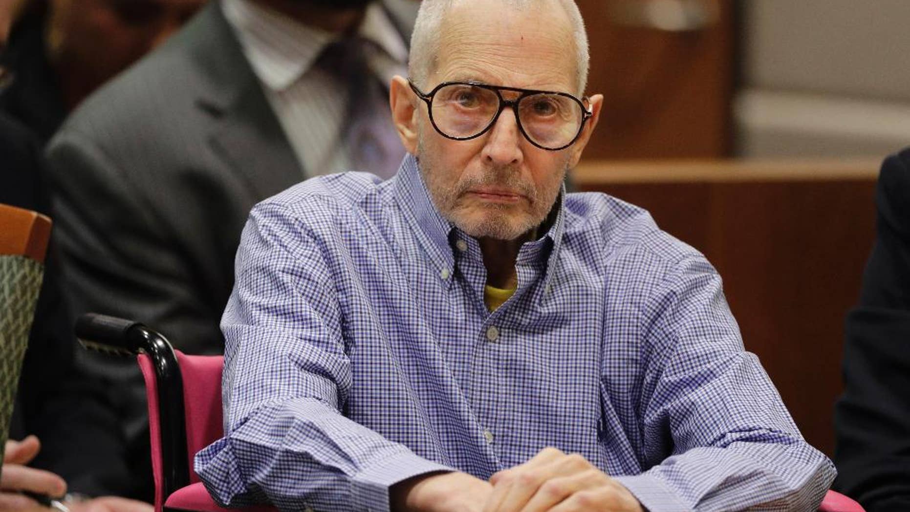 FILE - In this Dec. 21, 2016, file photo, real estate heir Robert Durst sits in a courtroom during a hearing in Los Angeles. A retired New York police detective says the missing wife of New York real estate heir Robert Durst once went to her neighbor's in pajamas and said her husband beat her and she feared he would kill her. James Varian testified Tuesday, April 25, 2017, that a neighbor reported Kathleen Durst had knocked on her Manhattan penthouse bedroom window for help. (AP Photo/Jae C. Hong, Pool, File)