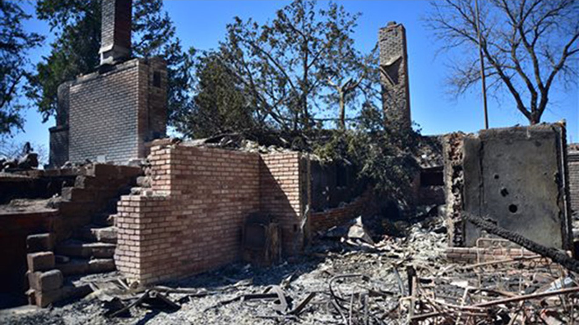 Fire damage to a home Thursday, March 24, 2016 near Medicine Lodge, Kan. A fire that started Tuesday in Oklahoma has now burnt near 400, 000 acres in Kansas and Oklahoma. (Andrew Whitaker/ The Hutchinson News via AP)