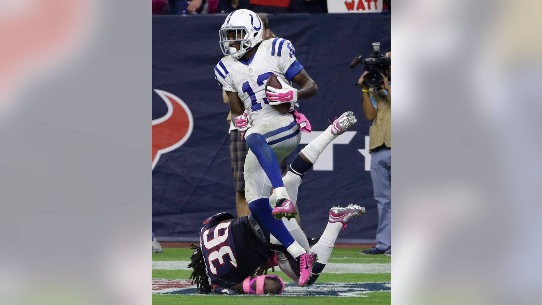 Indianapolis Colts' T.Y. Hilton (13) catches a pass for a touchdown as Houston Texans' D.J. Swearinger (36) defends the play during the second half of an NFL football game, Thursday, Oct. 9, 2014, in Houston. (AP Photo/David J. Phillip)