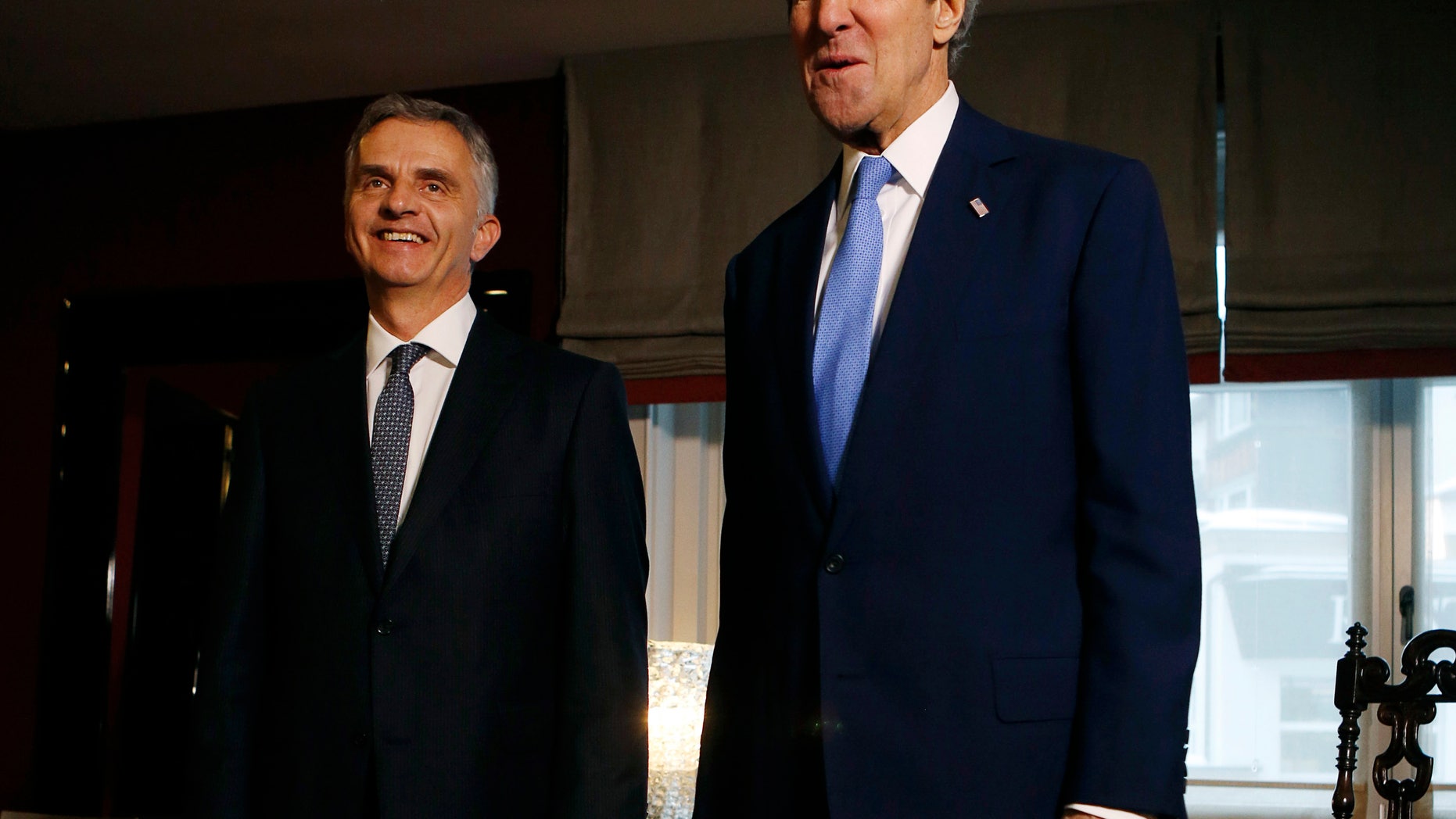 U.S. Secretary of State John Kerry, right, poses with Swiss President Didier Burkhalter for photographers in Davos, Switzerland, Friday, Jan. 24, 2014. Kerry is attending the annual World Economic Forum meeting in the Swiss Alps. (AP Photo/Gary Cameron, Pool)