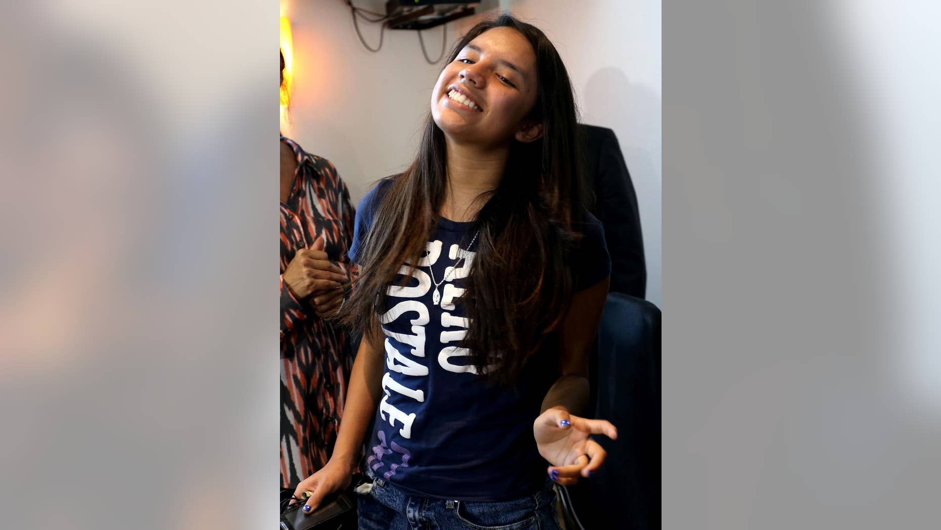 Alondra Luna Nunez smiles following a press conference after arriving to the Guanajuato International Airport in Silao, Mexico, Wednesday, April 22, 2015. The 14-year-old Mexican girl, who was taken from her school by police and sent kicking and screaming to the U.S., returned home after DNA tests showed she is not related to an American woman searching for her missing daughter. There was no immediate explanation of why authorities did not confirm her identity before sending her out of the country. (AP Photo/Mario Armas)