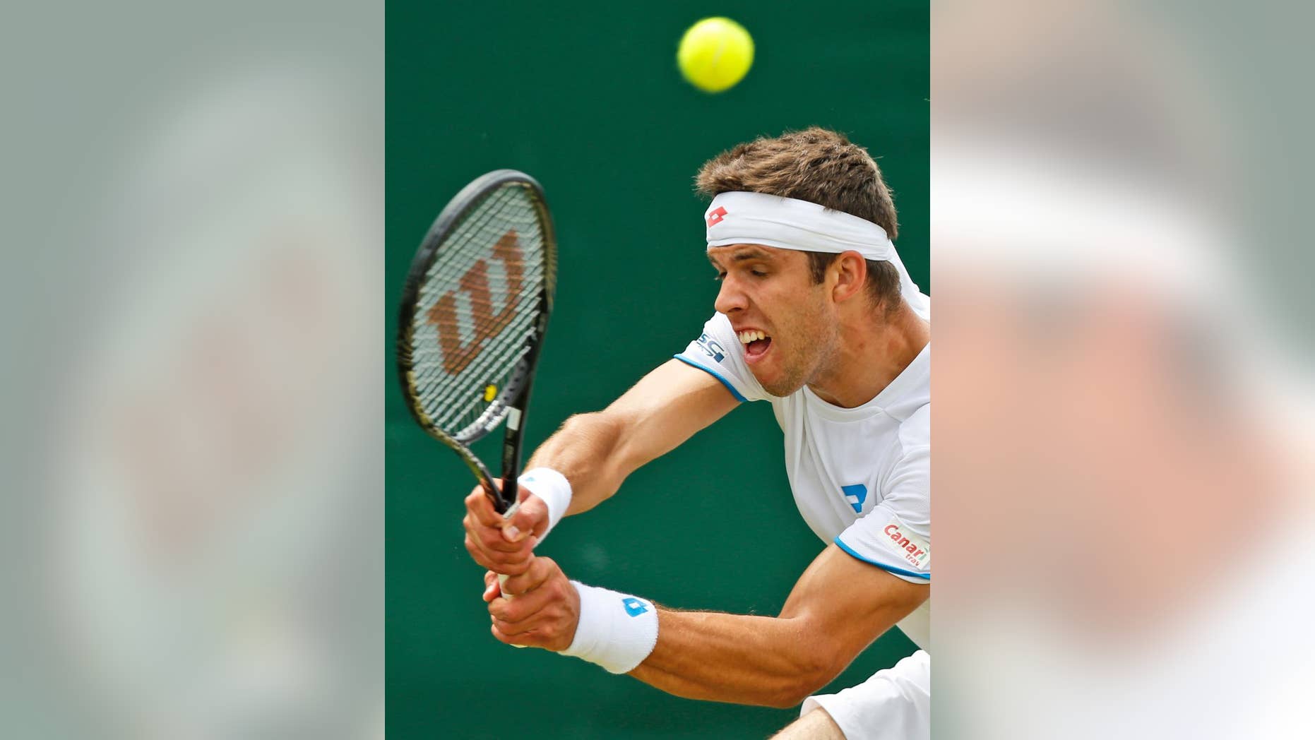 Jiri Vesely of the Czech Republic plays a return to Gael Monfils of France during their men's singles match at the All England Lawn Tennis Championships in Wimbledon, London, Thursday, June 26, 2014. (AP Photo/Sang Tan)