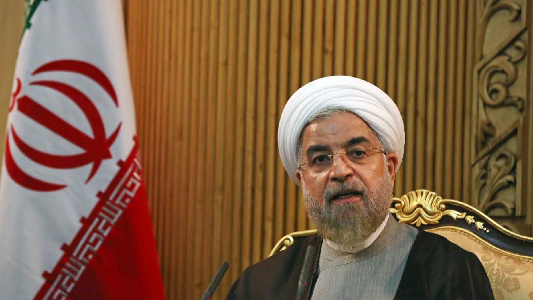 FLE - In this file photo taken Monday, Sept. 22, 2014, Iranian President Hassan Rouhani briefs media prior to departing Mehrabad airport to attend the United Nations General Assembly, in Tehran, Iran. Rouhani said Sunday, Jan. 4, 2015, that ongoing nuclear negotiations with world powers are a matter of "heart," not just centrifuges ahead of talks next week in Geneva. (AP Photo/Vahid Salemi, File)