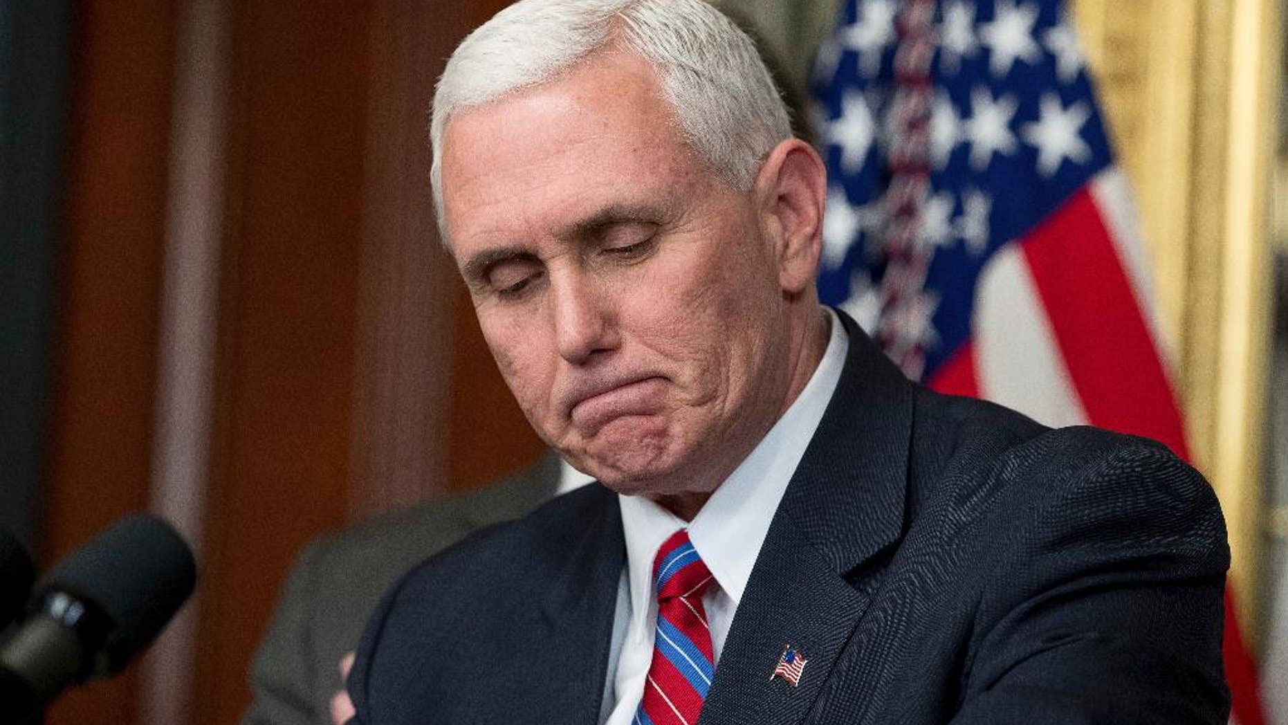 Vice President Mike Pence pauses while speaking before administering the oath of office to Energy Secretary Rick Perry, left, Thursday, March 2, 2017, in the Eisenhower Executive Office Building on the White House complex in Washington. (AP Photo/Andrew Harnik)