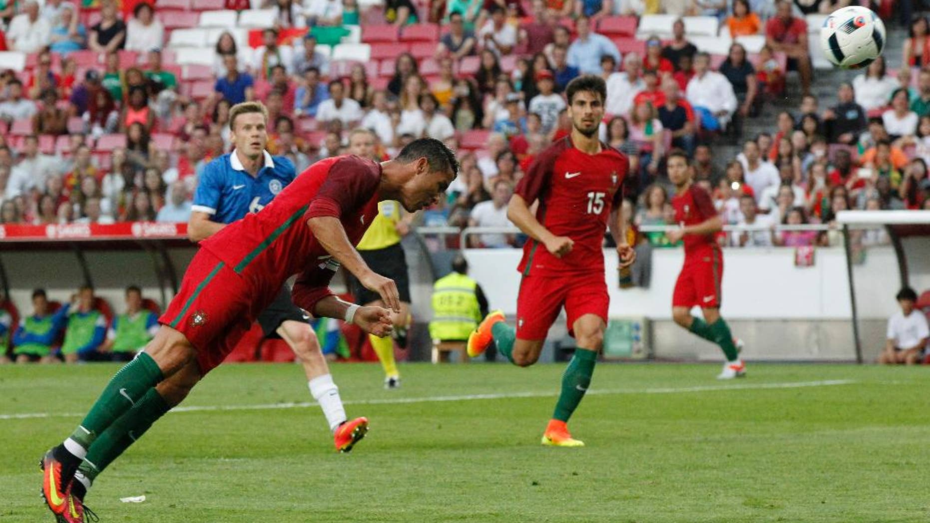 FILE - In this June 8, 2016, file photo, Portugal's Cristiano Ronaldo heads the ball to score against Estonia during a friendly soccer match in Lisbon, Portugal. American soccer fans can watch a quintuple-header of major international tournament matches Saturday, the first of six in the next week-and-a-half. (AP Photo/Steven Governo, File)