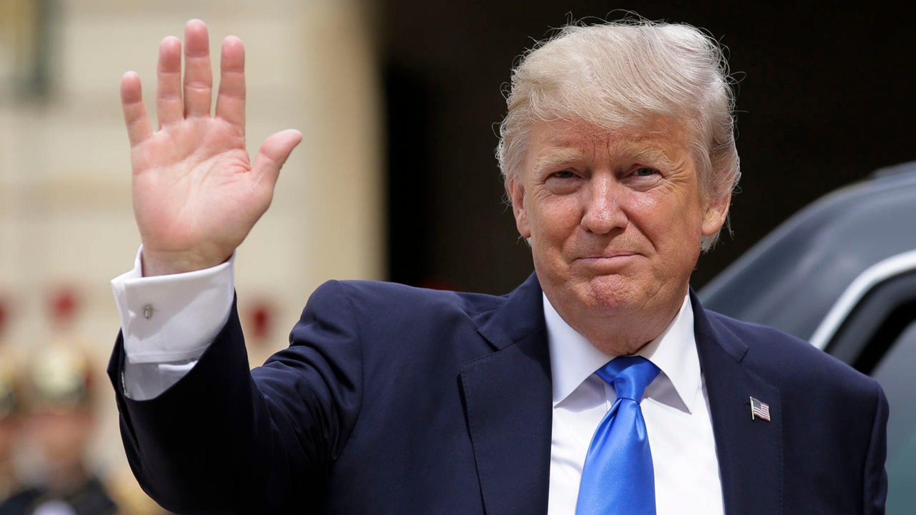 US President Donald Trump waves as he arrives for a meeting with French President Emmanuel Macron at the Elysee Palace in Paris, Thursday, July 13, 2017.