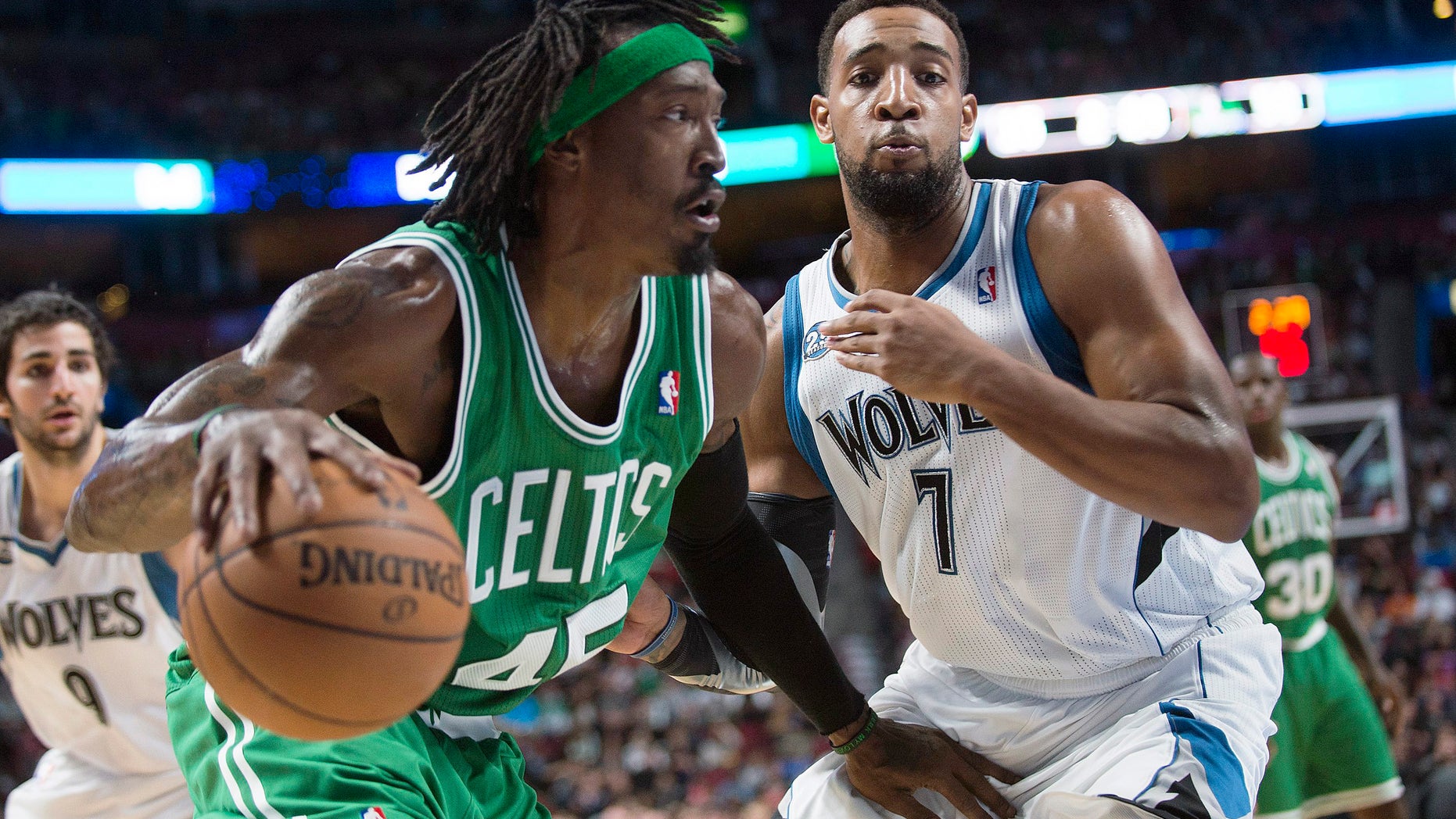 Boston Celtics' Gerald Wallace, left, drives to the net as Minnesota Timberwolves' Derrick Williams defends during the second quarter of an NBA preseason basketball game in Montreal, Sunday, Oct. 20, 2013. (AP Photo/The Canadian Press, Graham Hughes)