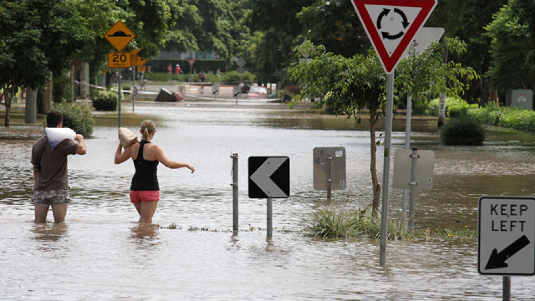 Jan. 13, 2011: Two local residents walk through floodwater after getting ice and food to take to their flooded residence in the suburb of New Farm in Brisbane, Australia