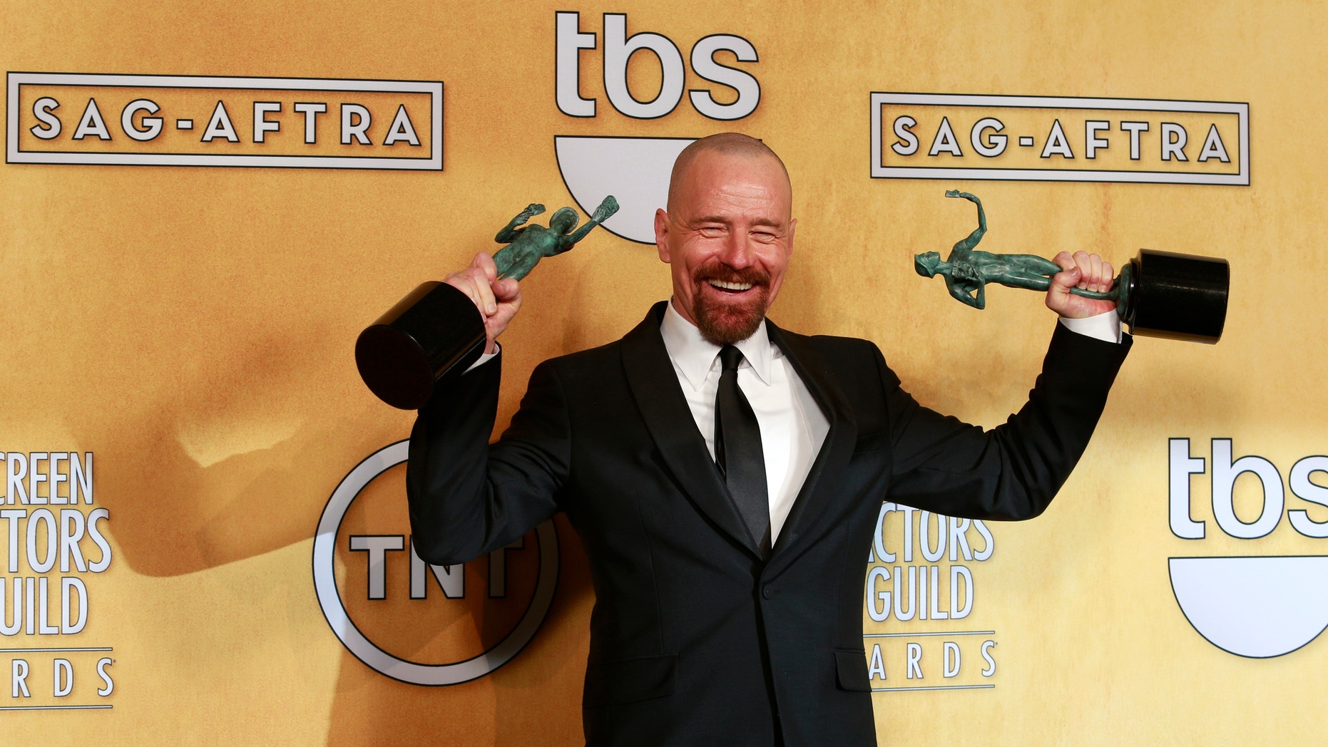 Bryan Cranston poses backstage with his awards for outstanding male actor in a drama series for "Breaking Bad" and for outstanding cast in a motion picture for "Argo" at the 19th annual Screen Actors Guild Awards in Los Angeles, California January 27, 2013.