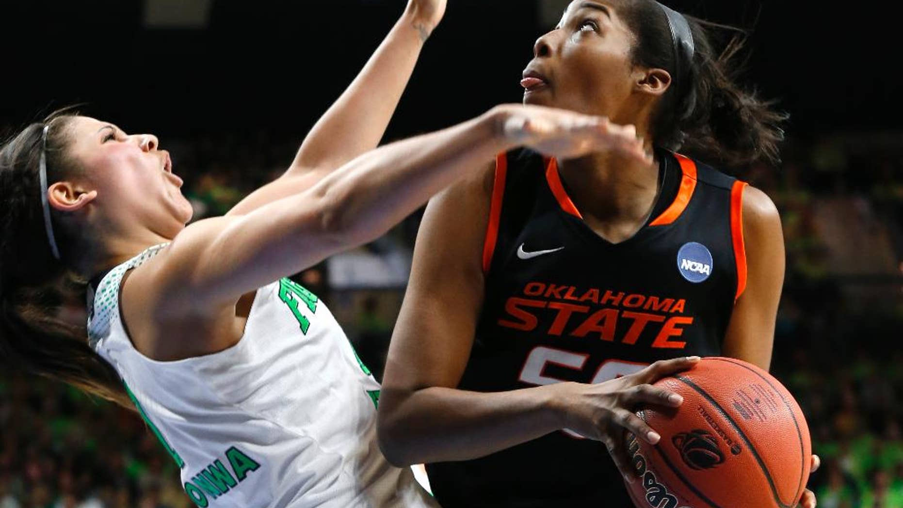 Oklahoma State center LaShawn Jones (55) drives against Notre Dame forward Natalie Achonwa (11) during the second half of of a regional semifinal in the NCAA college basketball tournament at the Purcell Pavilion in South Bend, Ind., Saturday, March 29, 2014. (AP Photo/Paul Sancya)