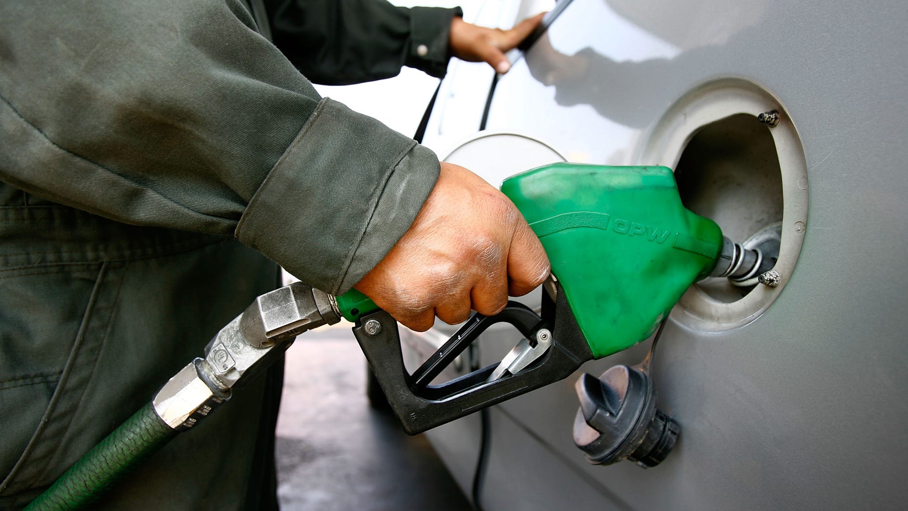 TIJUANA, MEXICO - JUNE 27: A Pemex gas station attendant fills a car registered with a California license plate on June 27, 2008 in Tijuana, Mexico. With the cost of gasoline in California around $4.60 per gallon, many drivers are buying their fuel in Mexico for about $3.20. There is a price to pay for cheaper gas though. Mexican gas is formulated with more sulfur than California gas and that can damage the emission control equipment on US cars, causing them to fail emissions tests and leading to expensive repairs. In addition, unless a driver has other business in Mexico, part of their fuel savings will be burned up idling in a line that can easily last for hours to get back into the US. (Photo by David McNew/Getty Images)