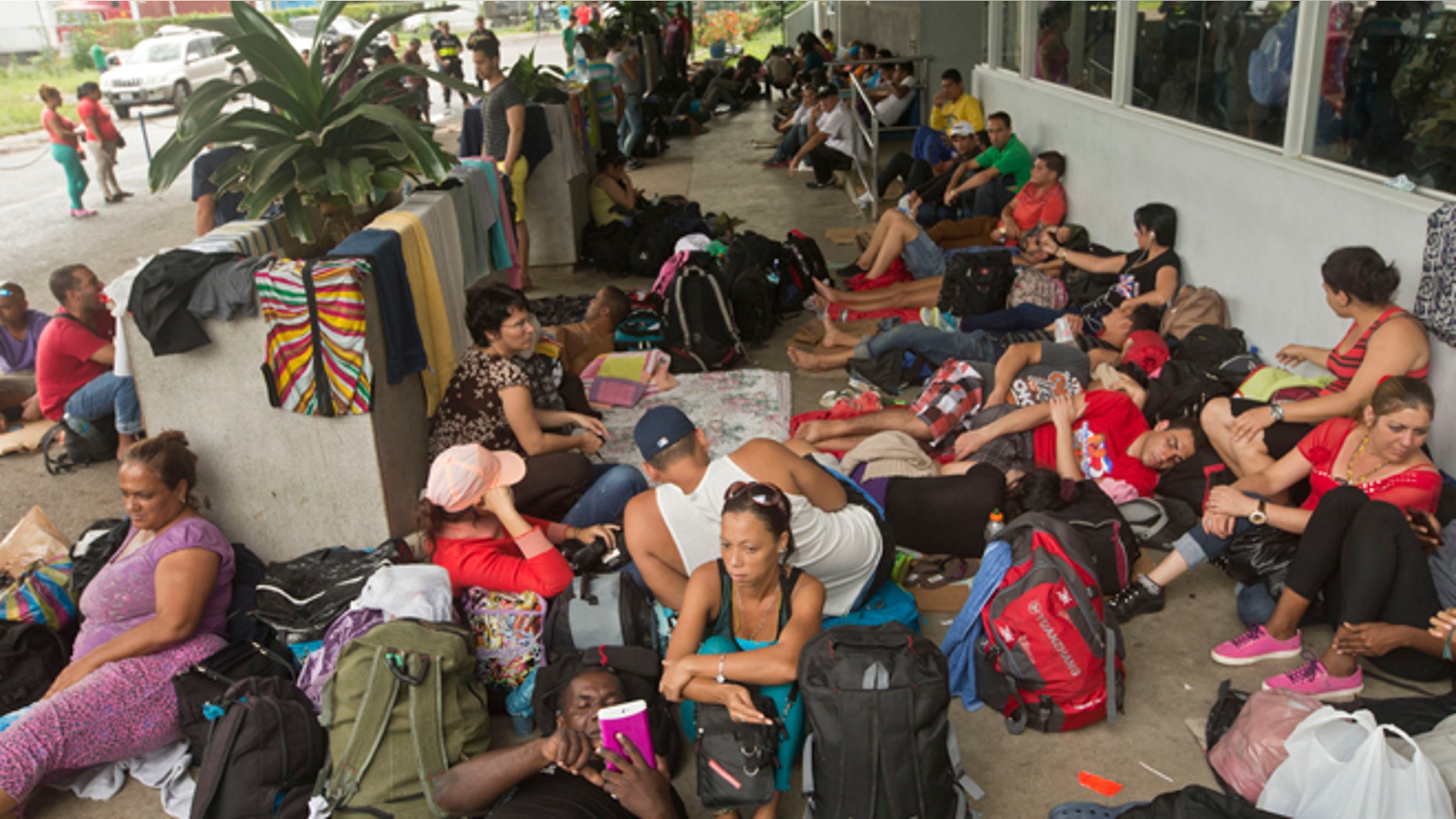 Cuban migrants sit outside a Costa Rican immigration building on the border with Nicaragua, in Peñas Blancas, Costa Rica, after Nicaragua closed its border to all Cuban migrants, leaving them stuck in Costa Rica. (AP Photo/Esteban Felix, File)
