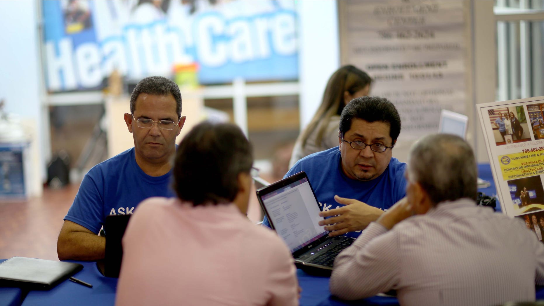 Insurance agents help people with the Affordable Care Act on November 5, 2013 in Miami, Florida.