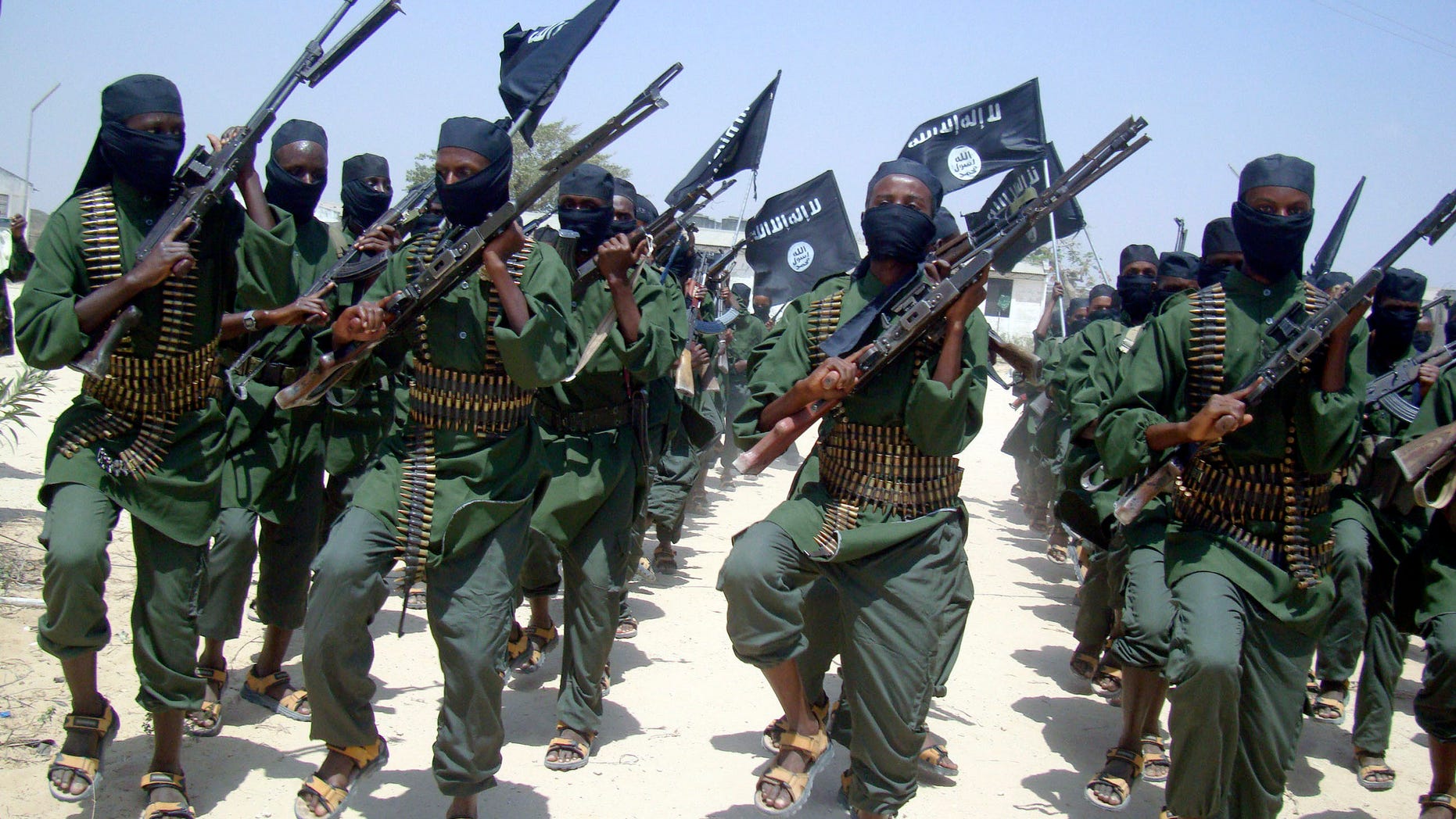 FILE - In this Thursday, Feb. 17, 2011 file photo, al-Shabab fighters march with their weapons during military exercises on the outskirts of Mogadishu, Somalia. Twitter suspended the account used by the Somali militants on Friday, Jan. 25, 2013, after the insurgents used the micro-blogging site to post a hostage video and death threat. (AP Photo/Mohamed Sheikh Nor, File)