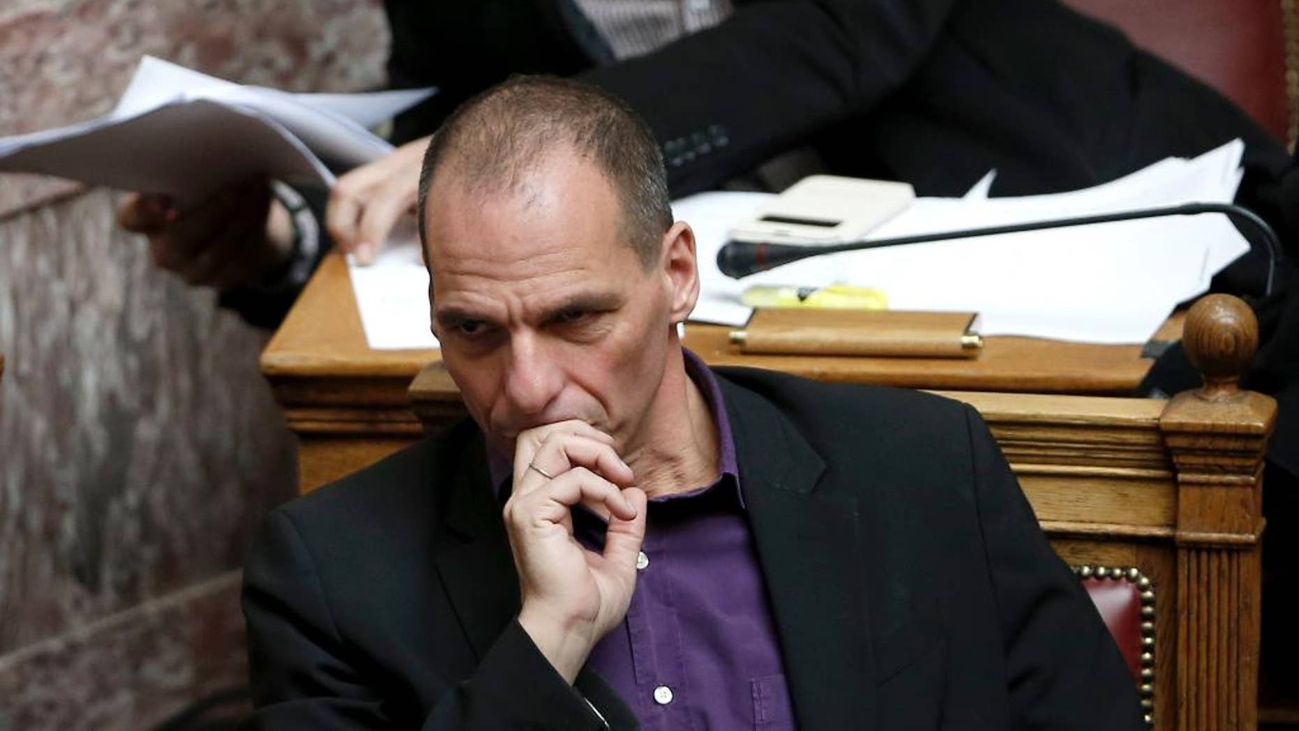 Greek Finance Minister Yanis Varoufakis attends a parliament session before the vote of an anti-poverty bill, the first piece of legislation from the left-wing government, in Athens, on Wednesday, March 18, 2015. Tsipras insisted Wednesday his government will honor an election promise to end budget austerity — a note of defiance ahead of an expected meeting with the leaders of Germany and France on the country's troubled bailout. (AP Photo/Petros Giannakouris)