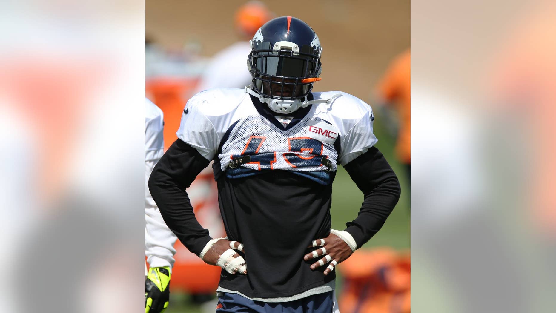 Denver Broncos safety T.J. Ward takes break during the morning session at the team's NFL training camp at Broncos headquarters in Englewood, Colo., on Friday, Aug. 1, 2014. (AP Photo/David Zalubowski)