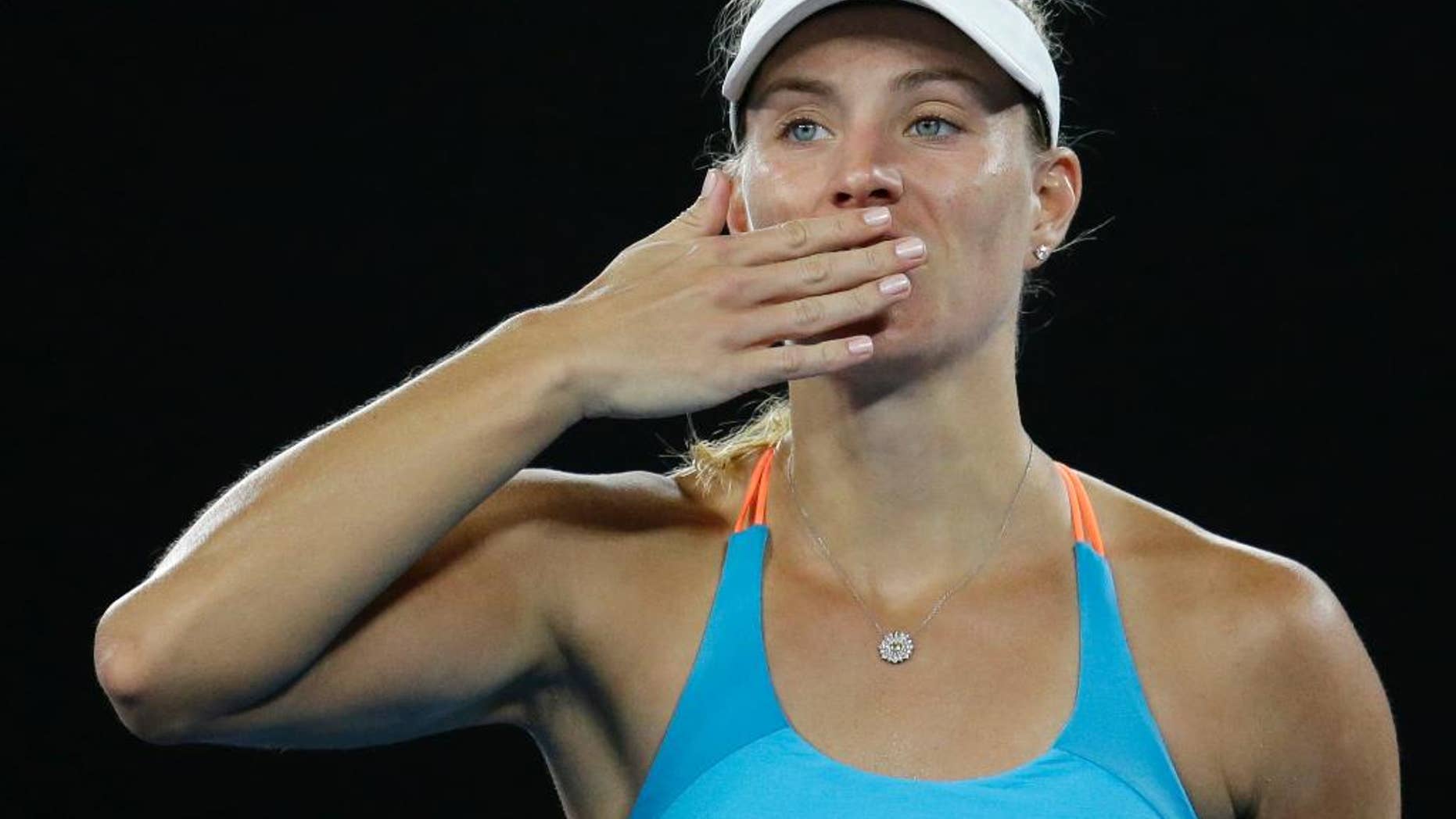 Germany's Angelique Kerber blows a kiss to the crowd after defeating Ukraine's Lesia Tsurenko during their first round match at the Australian Open tennis championships in Melbourne, Australia, Monday, Jan. 16, 2017. (AP Photo/Aaron Favila)