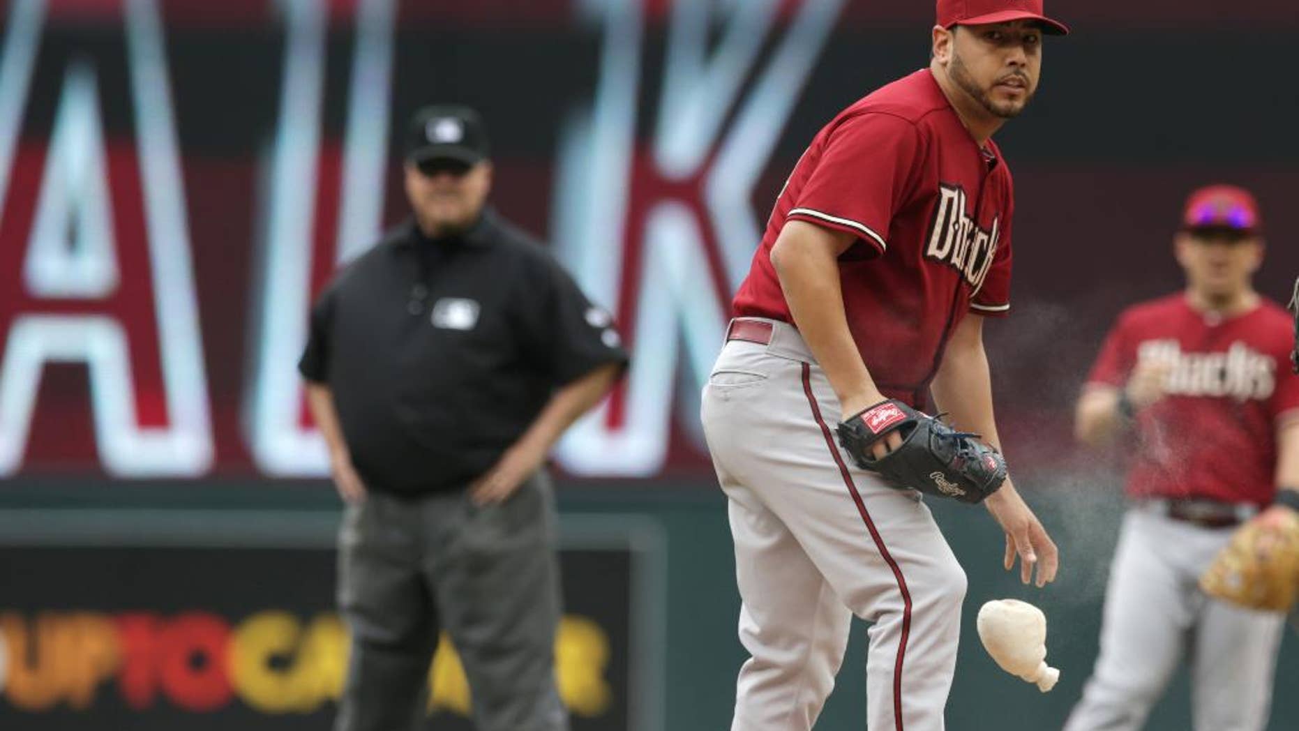 Arizona Diamondbacks' pitcher Vidal Nuno looks on after giving up a walk to Minnesota Twins' Kennys Vargas in the first inning of a baseball game, Wednesday, Sept. 24, 2014, in Minneapolis. Nuno gave up three walks in the first. (AP Photo/Jim Mone)