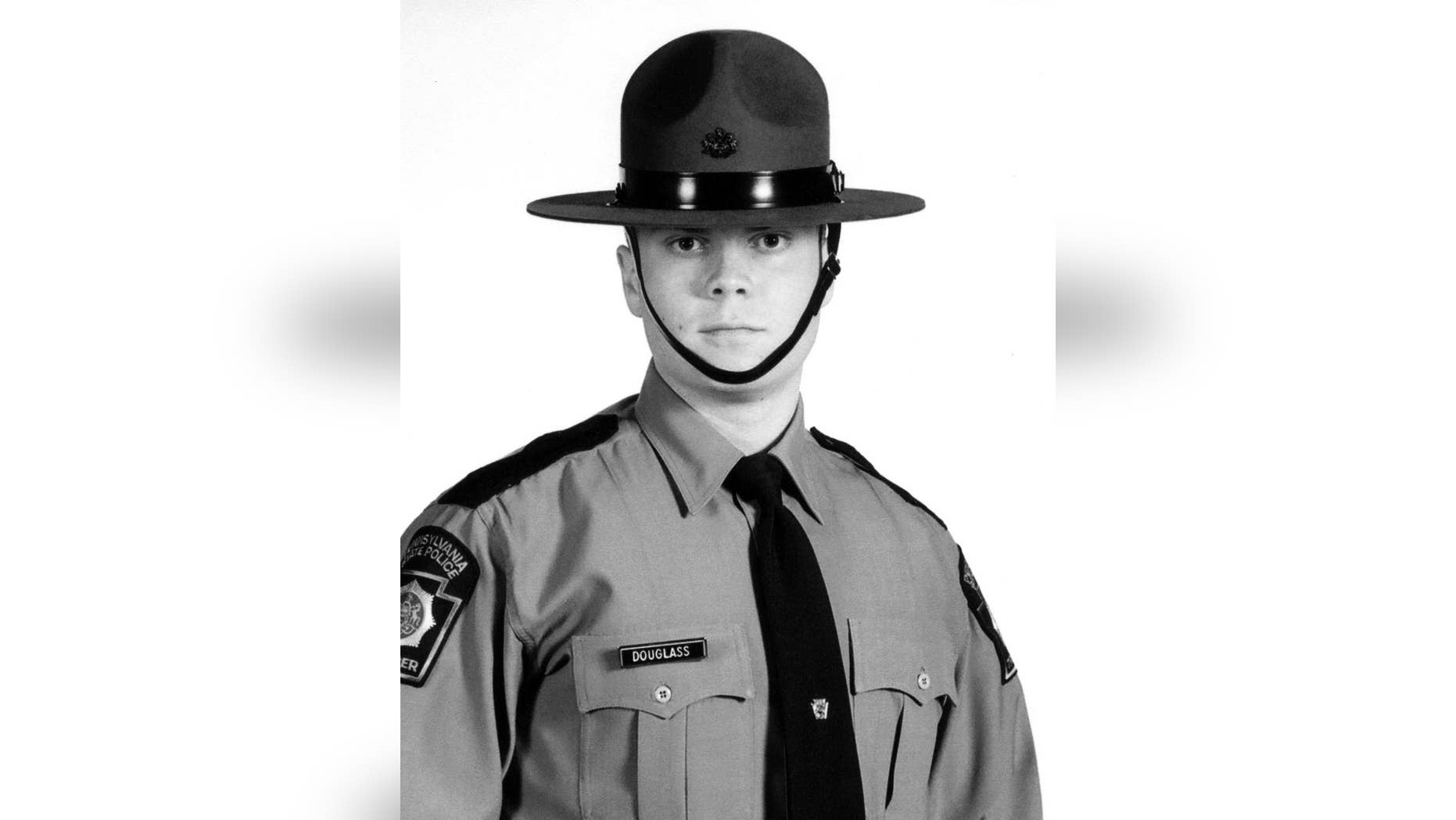 FILE - This undated file photo provided by the Pennsylvania State Police shows Trooper Alex Douglass. Douglass, wounded in the Sept. 12 shooting outside the Blooming Grove barracks that killed Cpl. Bryon Dickson, made his first public remarks Saturday, March 28, 2015, as the borough of Dunmore named a road after Dickson. Douglass, who walked with a cane, told reporters he feels good and no longer needs crutches to get around. He says he has had 16 surgeries with one more scheduled next month. (AP Photo/Pennsylvania State Police, File)