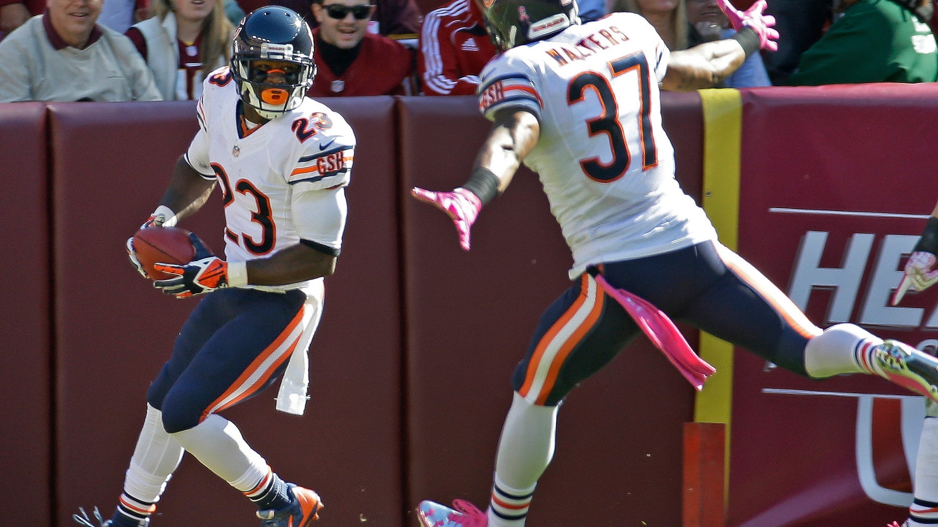Chicago Bears wide receiver Devin Hester turns and looks at his teammate free safety Anthony Walters after scoring this 19th touchdown on a kickoff return during the first half of a NFL football game against the Washington Redskins in Landover, Md., Sunday, Oct. 20, 2013. (AP Photo/Alex Brandon)