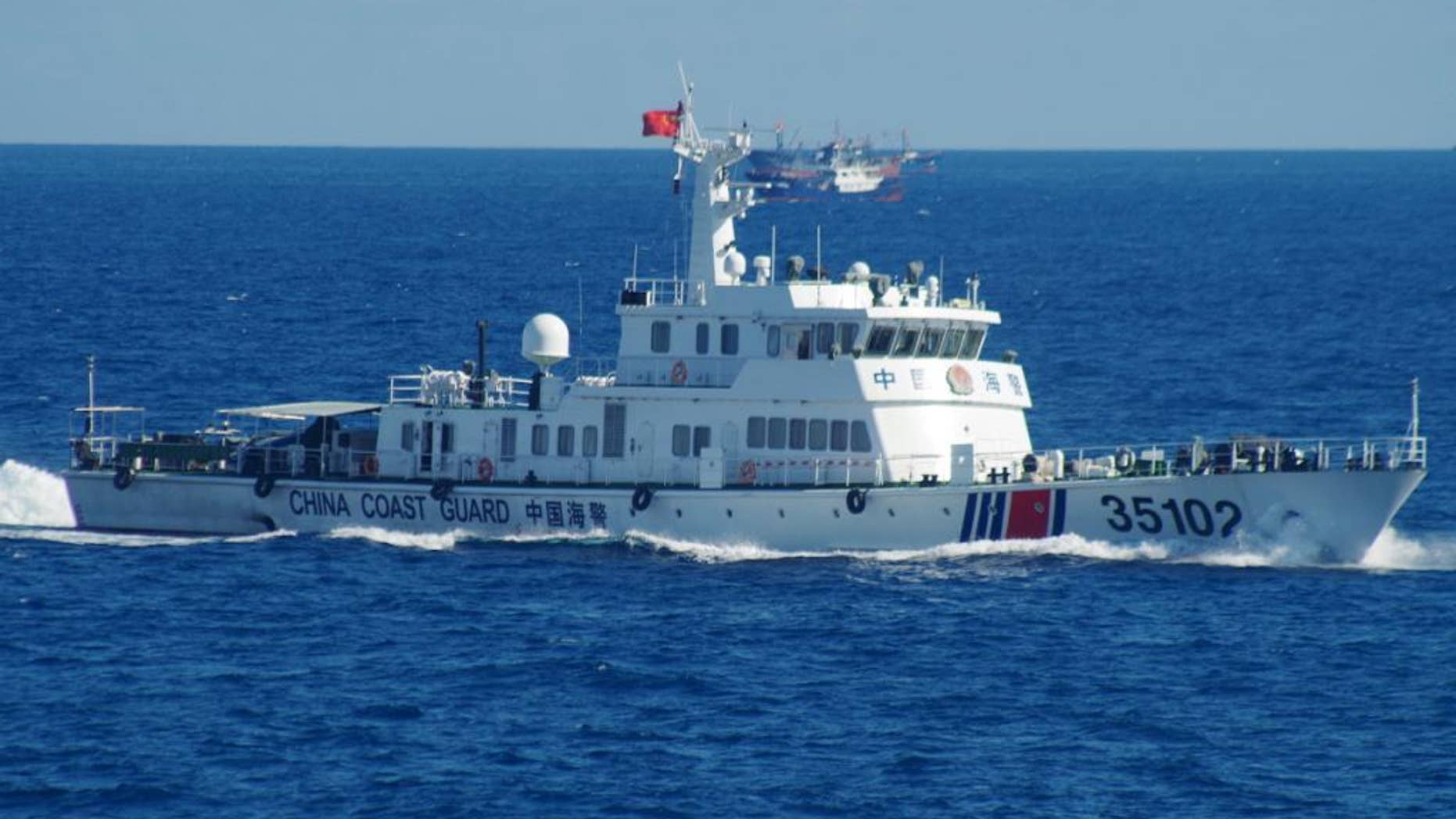 In this photo released by the 11th Regional Coast Guard Headquarters of Japan, a Chinese coast guard vessel sails near disputed East China Sea islands Saturday, Aug. 6, 2016. Japan's Foreign Ministry said in a statement it filed the protest after Japan's coast guard spotted the vessels Saturday along with a fleet of 230 Chinese fishing boats swarming around the Japanese-controlled Senkaku Islands. China also claims the islands, calling them the Diaoyu. (11th Regional Coast Guard Headquarters via AP)
