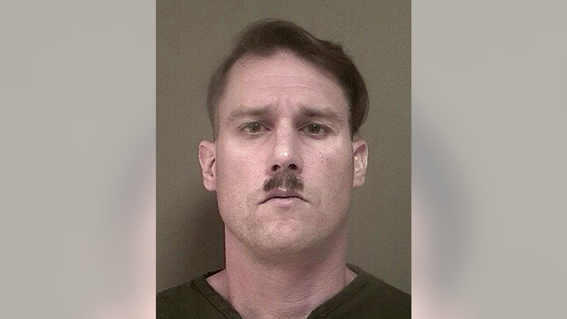 This photo provided Monday May 16, 2016 by New Jersey's Ocean County Jail shows Bruce Post III, who was arrested by Lacey, N.J., police on Sunday, May 15, 2016 after authorities ay they found a large cache of weapons and ammunition in the New Jersey Pinelands. Police were in the area looking for trespassers and criminal activity when they found the 42-year-old dressed in combat gear, another man nearby, and an AK-47, a 9mm handgun, eight 30-round magazines, a 100-round drum magazine and other ammunition police said was hidden in the woods. Post was charged with illegally possessing a weapon as a felon and several weapons counts. (Ocean County Jail via AP)