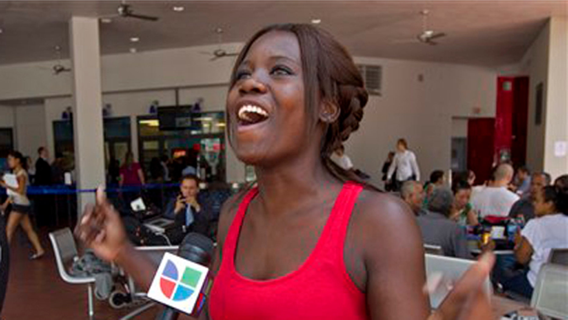 FILE: June 15, 2012: Niouseline St. Jean, from Turks and Caicos Islands who lives in the U.S. illegally reacts to a new immigration ruling for students.