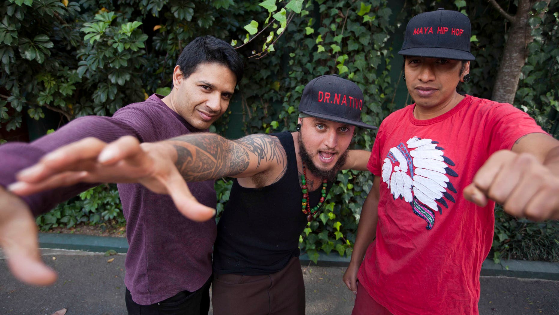 In this Feb. 5, 2015 photo, musicians from the band "Balam Ajpu," from left, Danilo Rodriguez, Juan Martinez a.k.a. "Dr. Native," and Rene Dionisio a.k.a. Tz´utu Baktun Kan pose for photos at a recording studio in Guatemala City. The band, whose name means Jaguar Warrior or Warrior of Light, raps in the ancient Mayan Tz'utujil language with the goal of making it cool for kids and teaching them their ancestorsâ stories and ways. (AP Photo/Moises Castillo)