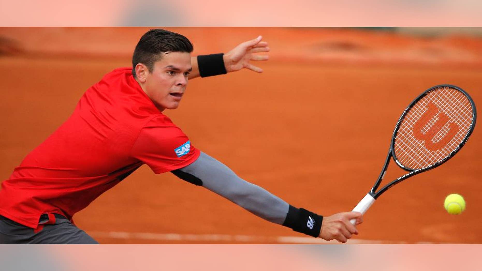 Canada's Milos Raonic returns in the fourth round match of the French Open tennis tournament against Spain's Marcel Granollers at the Roland Garros stadium, in Paris, France, Sunday, June 1, 2014. Raonic won in three sets 6-3, 6-3, 6-3. (AP Photo/Michel Spingler)