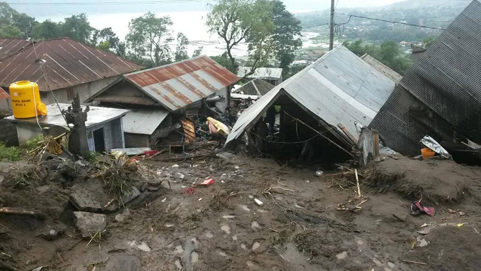 Houses are seen buried under the mud following a landslide in Songan village on Bali island, Indonesia, Friday, Feb. 10, 2017. A number of people including young children were killed in the landslides on the tourist island that wiped out several homes, Indonesia's disaster mitigation agency said. (AP Photo)