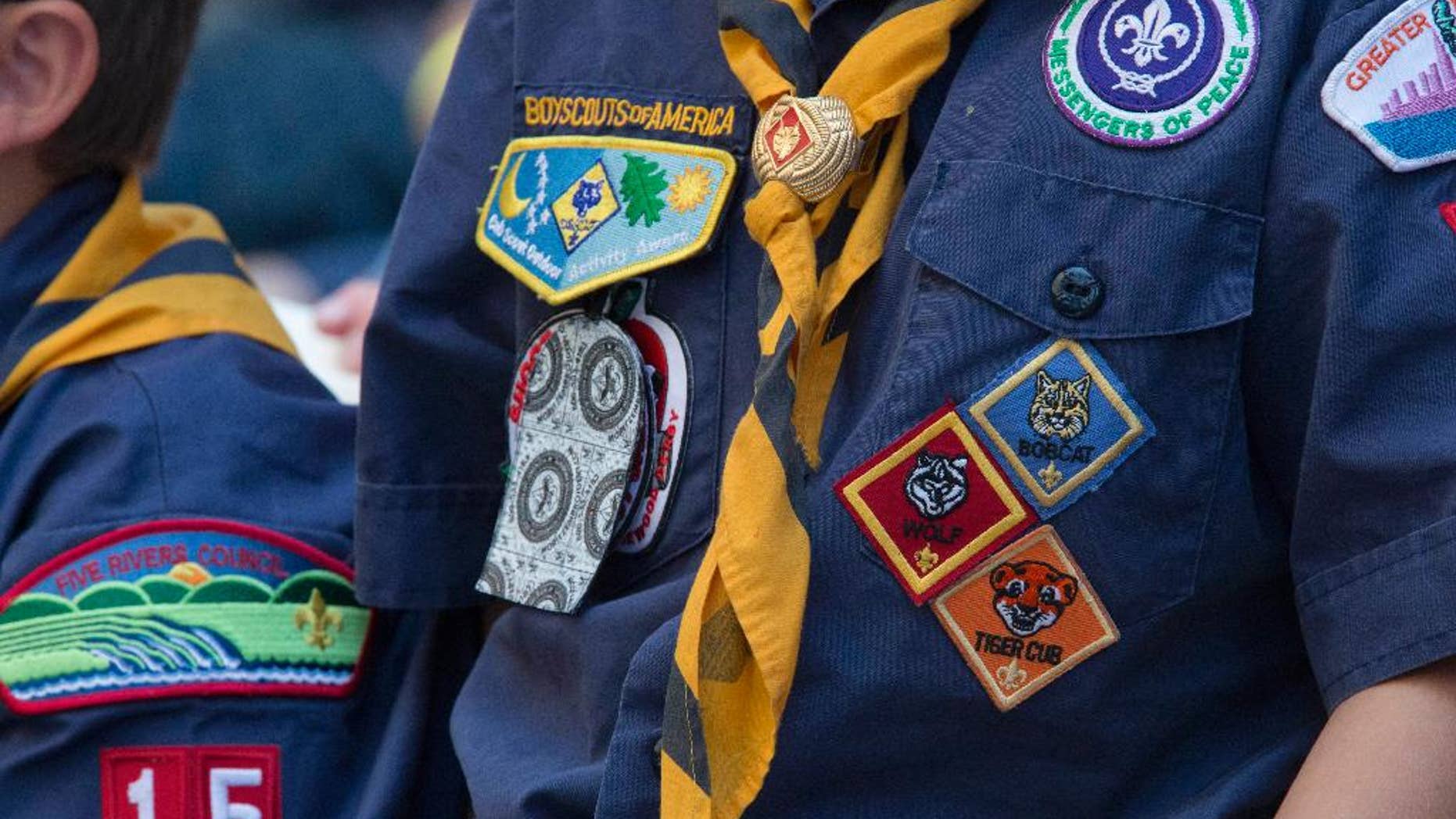 FILE- In this June 25, 2016, file photo, Cub Scouts watch a race during the Second Annual World Championship Pinewood Derby in New York's Times Square. The Boy Scouts of America announced Monday, June 25, 2016, that it will allow transgender children who identify as boys to enroll in its boys only programs. (AP Photo/Mary Altaffer, File)