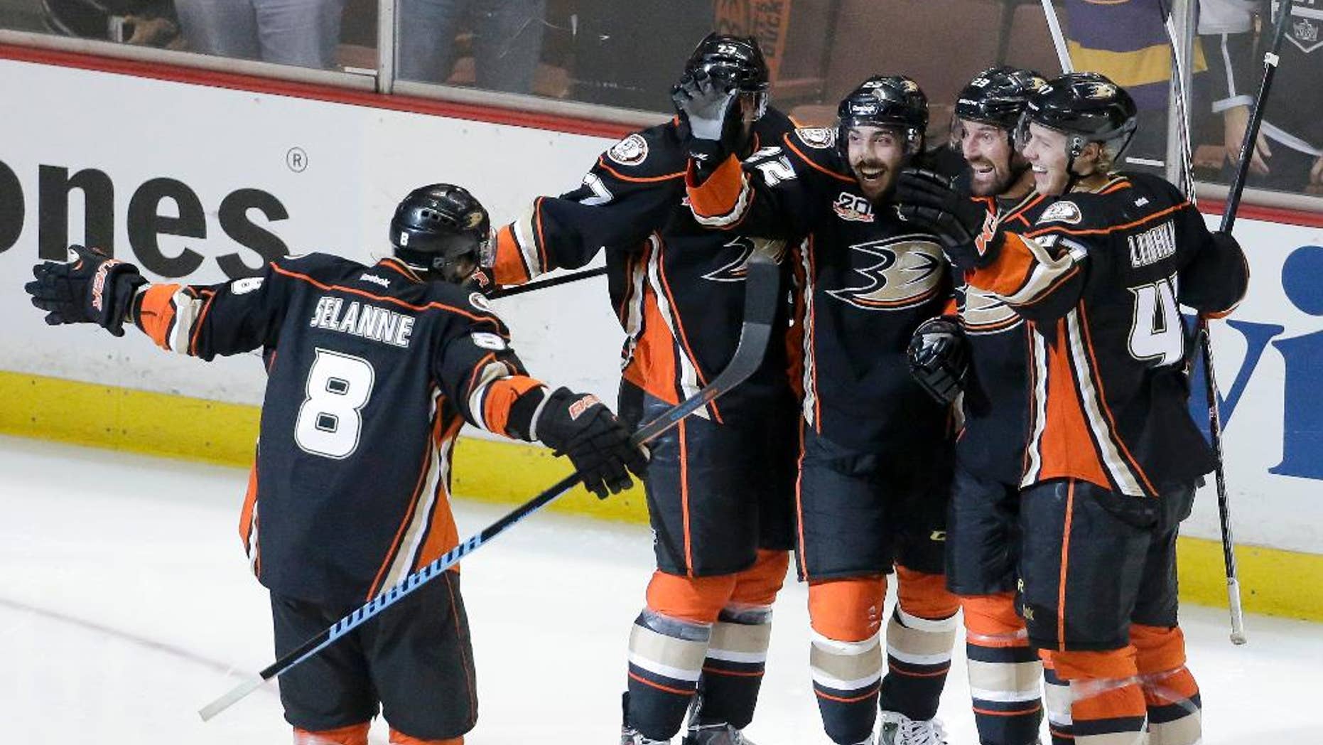 Members of the Anaheim Ducks celebrate Mathieu Perreault's goal during the second period in Game 5 of an NHL hockey second-round Stanley Cup playoff series against the Los Angeles Kings in Anaheim, Calif., Monday, May 12, 2014. (AP Photo/Chris Carlson)