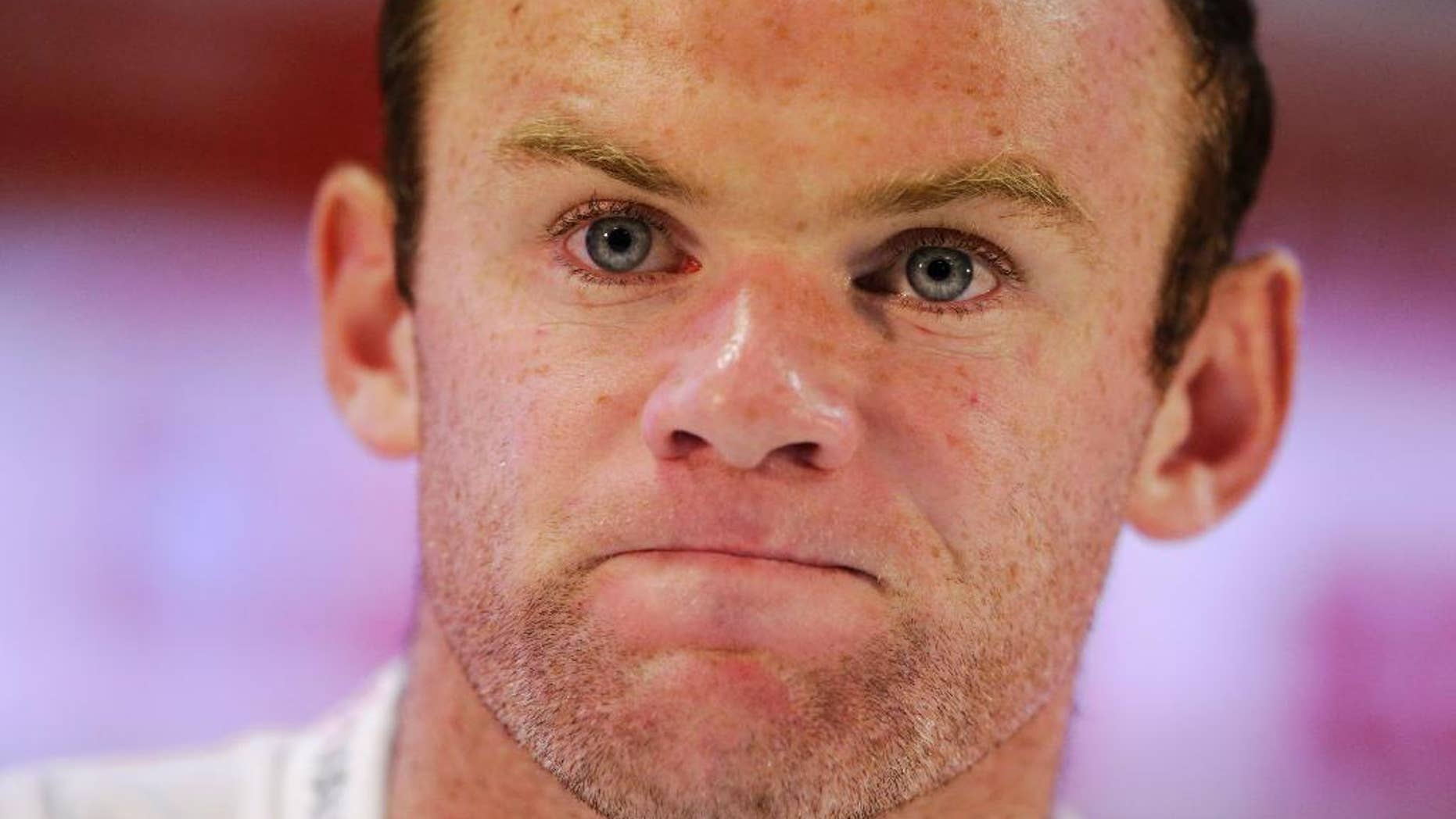 England national soccer team player Wayne Rooney listens to a journalist's question during a press conference after a training session for the 2014 soccer World Cup at the Urca military base in Rio de Janeiro, Brazil, Wednesday, June 11, 2014. The England soccer team are staying in Rio de Janeiro as their base city for the 2014 soccer World Cup. (AP Photo/Matt Dunham)