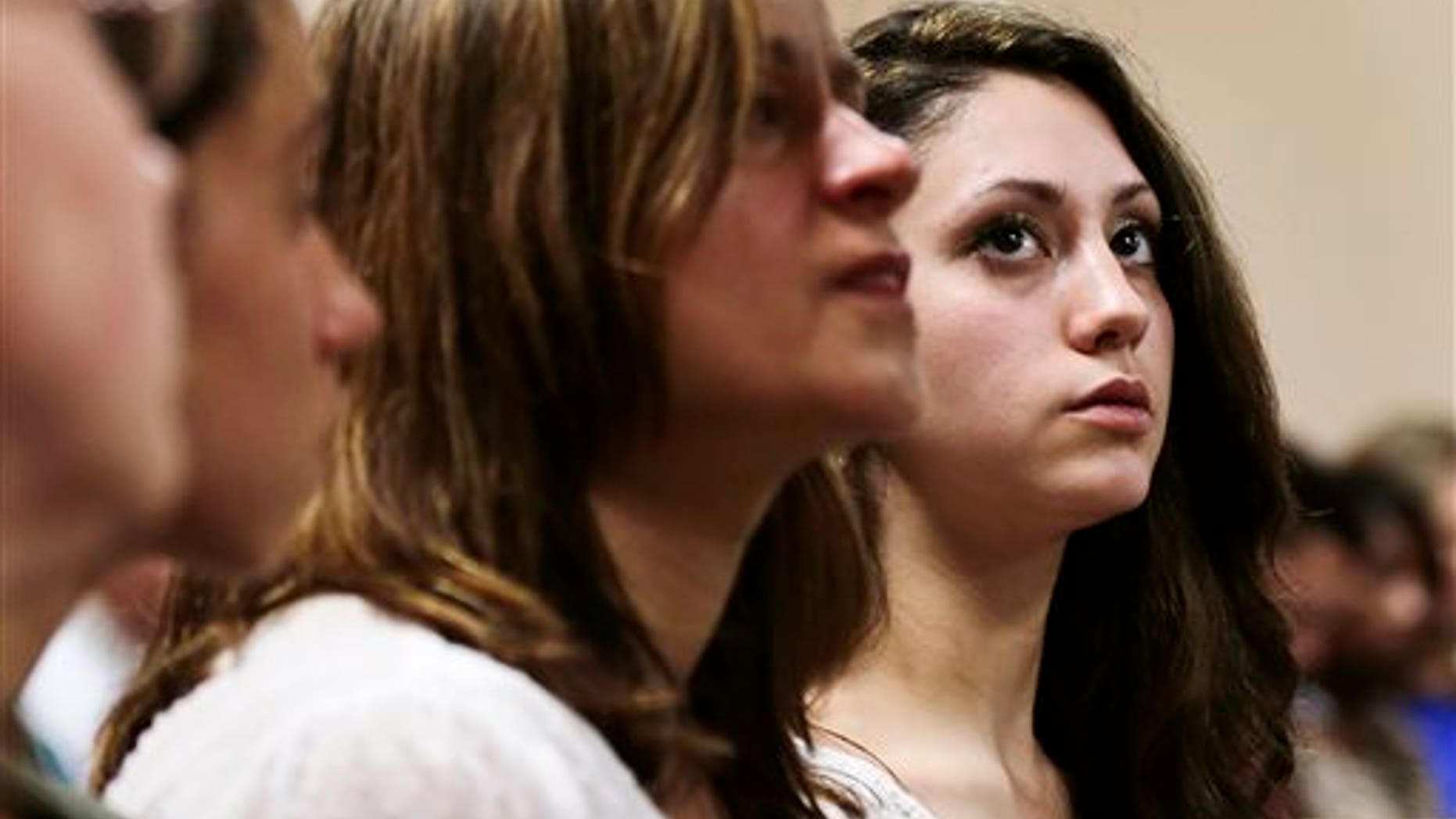 Abigail Hernandez, right, sits with family and friends as she listens to her mother Zenya Hernandez, center, talk with N.H. Senior Assistant Attorney General Jane Young, right, prior to the arraignment of Nathaniel Kibby, 34, of Gorham, N.H. at Conway District Court in Conway, N.H., Tuesday, July 29, 2014. Kibby was charged with kidnapping Abigail Hernandez nine months ago was ordered held on $1 million bail after a brief court appearance Tuesday. (AP Photo/Charles Krupa, Pool)