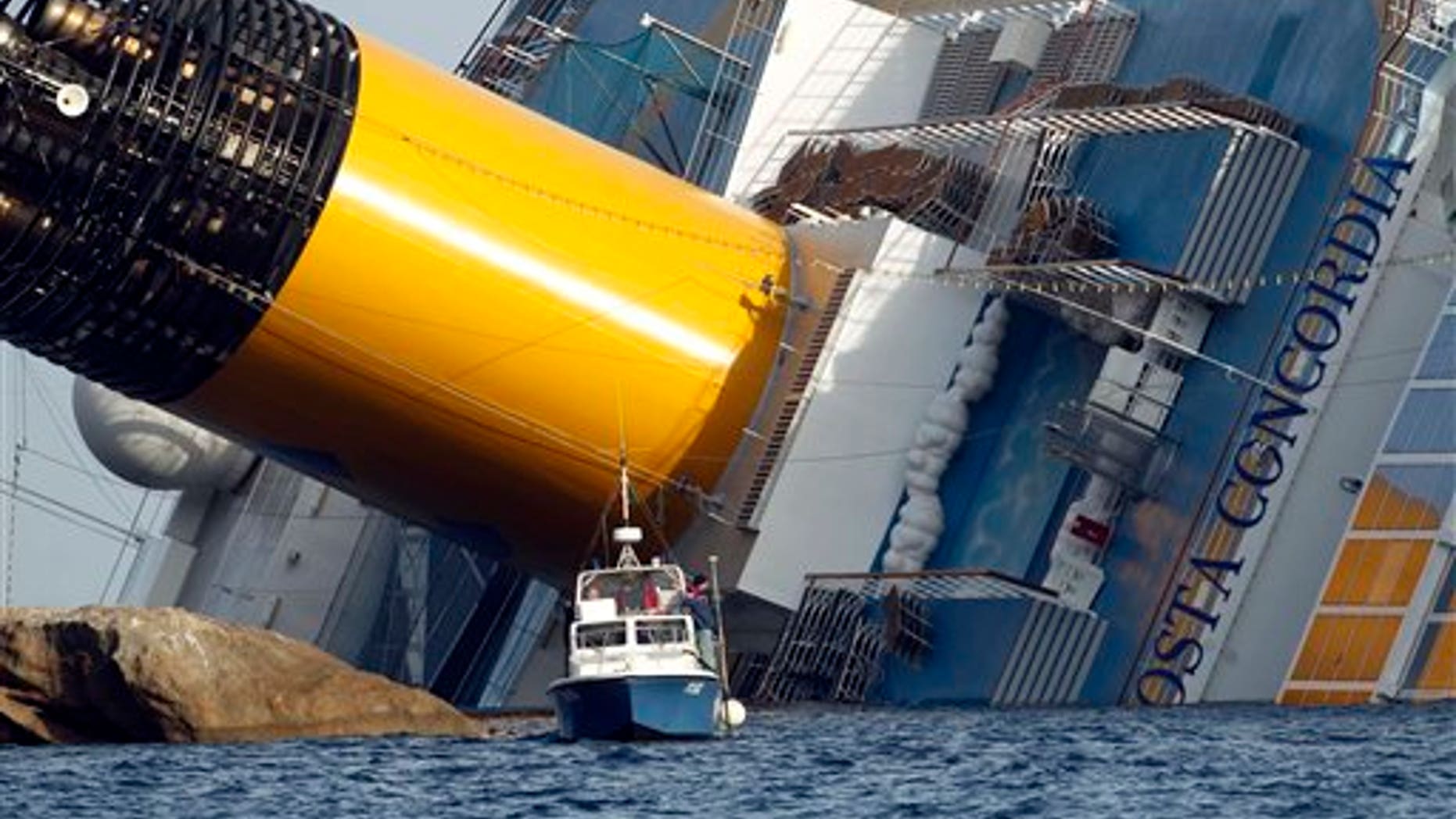Jan. 22: A police boat sails by the grounded cruise ship Costa Concordia, off the Tuscan island of Giglio, Italy. Rescuers on Sunday resumed searching the above-water section of the capsized Costa Concordia cruise liner, but choppy seas kept divers from exploring the submerged part, where officials have said there could be bodies.