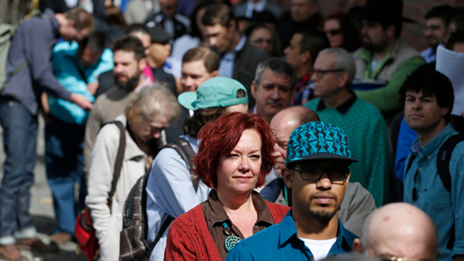 Job seekers line up to attend a job fair in Downtown Denver.