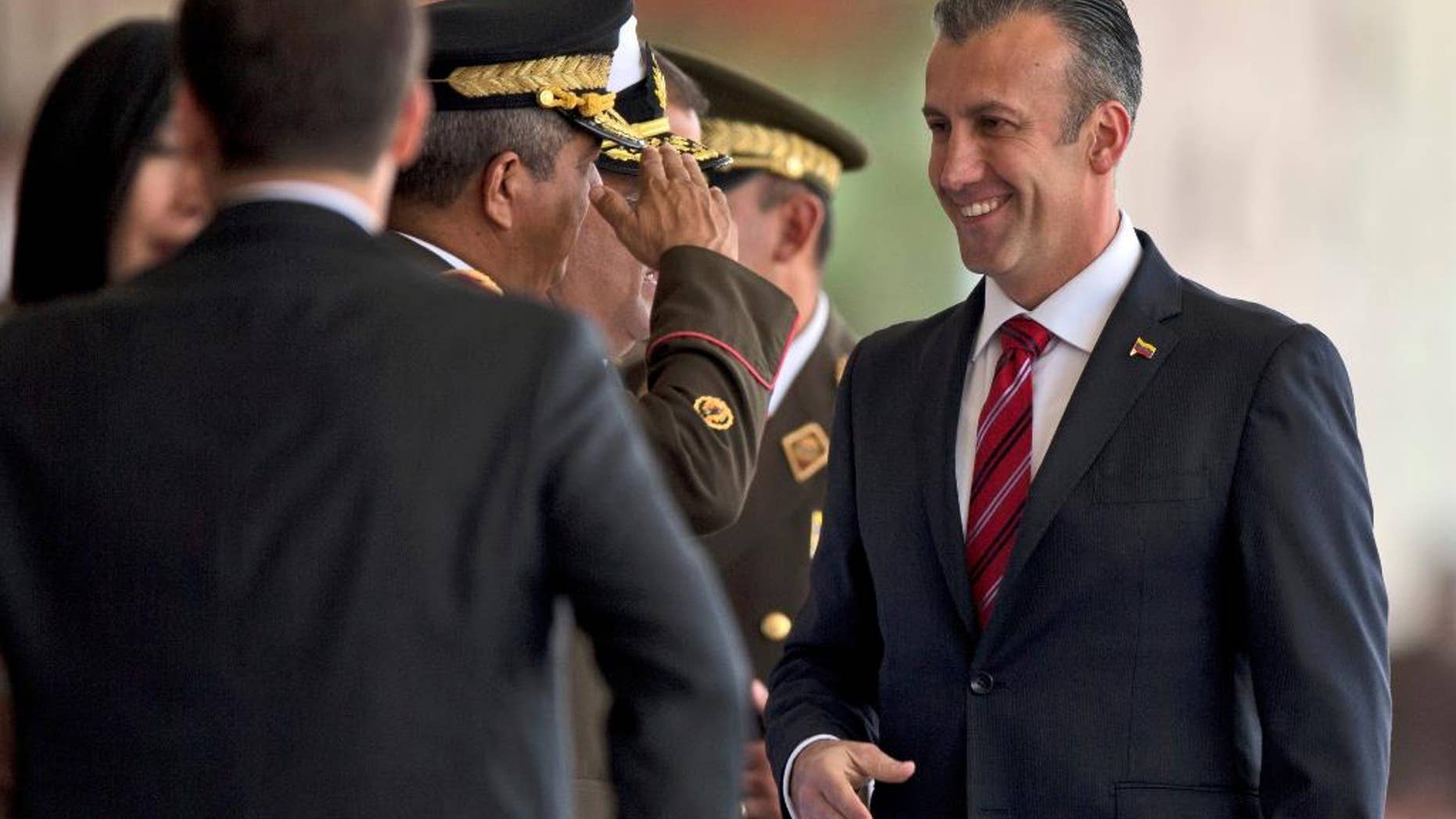Feb. 1, 2017: Venezuela's Vice-President Tareck El Aissami, right, is saluted by Boilivarian Army officer upon his arrival for a military parade at Fort Tiuna in Caracas.