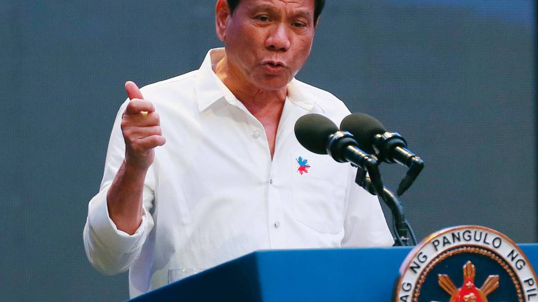 FILE - In this Thursday, Oct. 13, 2016, file photo, Philippine President Rodrigo Duterte gestures during his address to a Filipino business sector in suburban Pasay city, south of Manila, Philippines. Duterte acknowledged Sunday, Oct. 16, 2016, that he can be impeached if he concedes the country's territorial claims in the South China Sea in upcoming talks with Chinese President Xi Jinping and other Chinese leaders in Beijing. (AP Photo/Bullit Marquez, File)