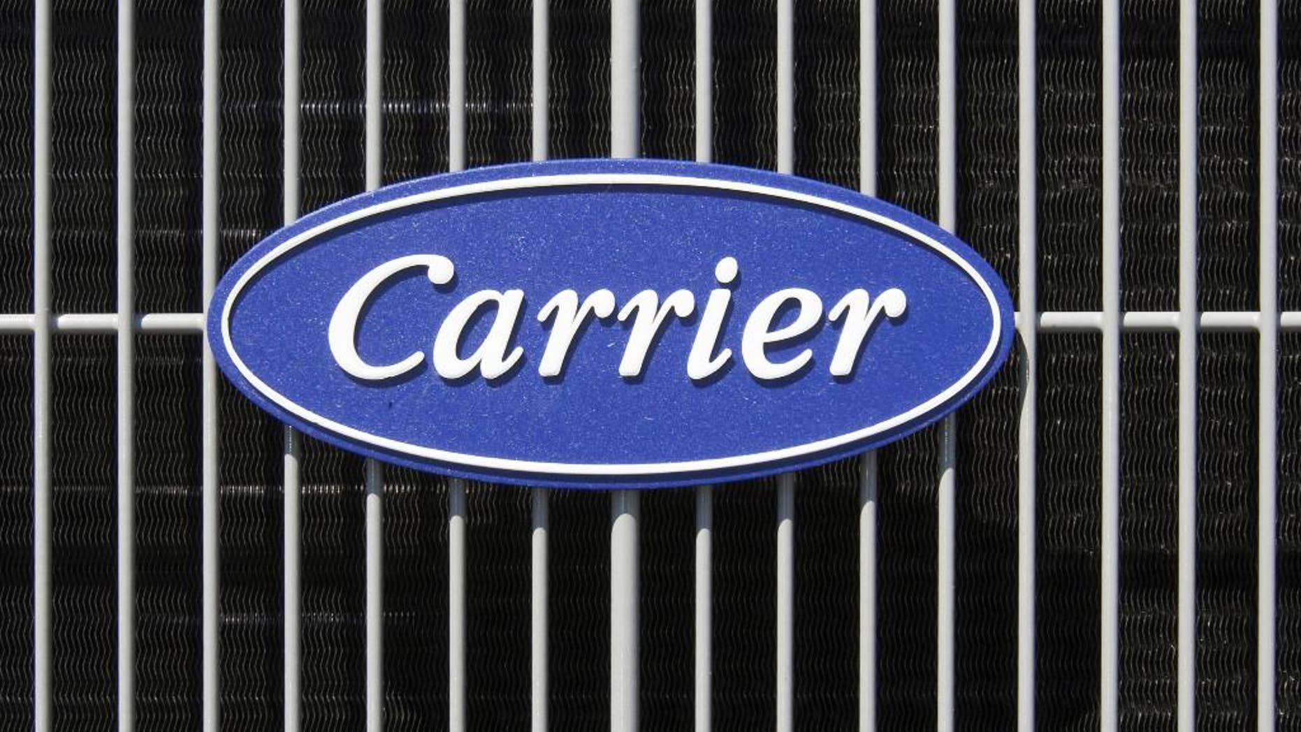 FILE - This April 21, 2009, file photo shows the Carrier logo on an air conditioning unit in Omaha, Neb. Carrier and President-elect Donald Trump reached an agreement to keep nearly 1,000 jobs in Indiana. Trump and Vice President-elect Mike Pence planned to travel to Indiana on Thursday, Dec. 1, 2016, to unveil the agreement alongside company officials. (AP Photo/Nati Harnik, File)