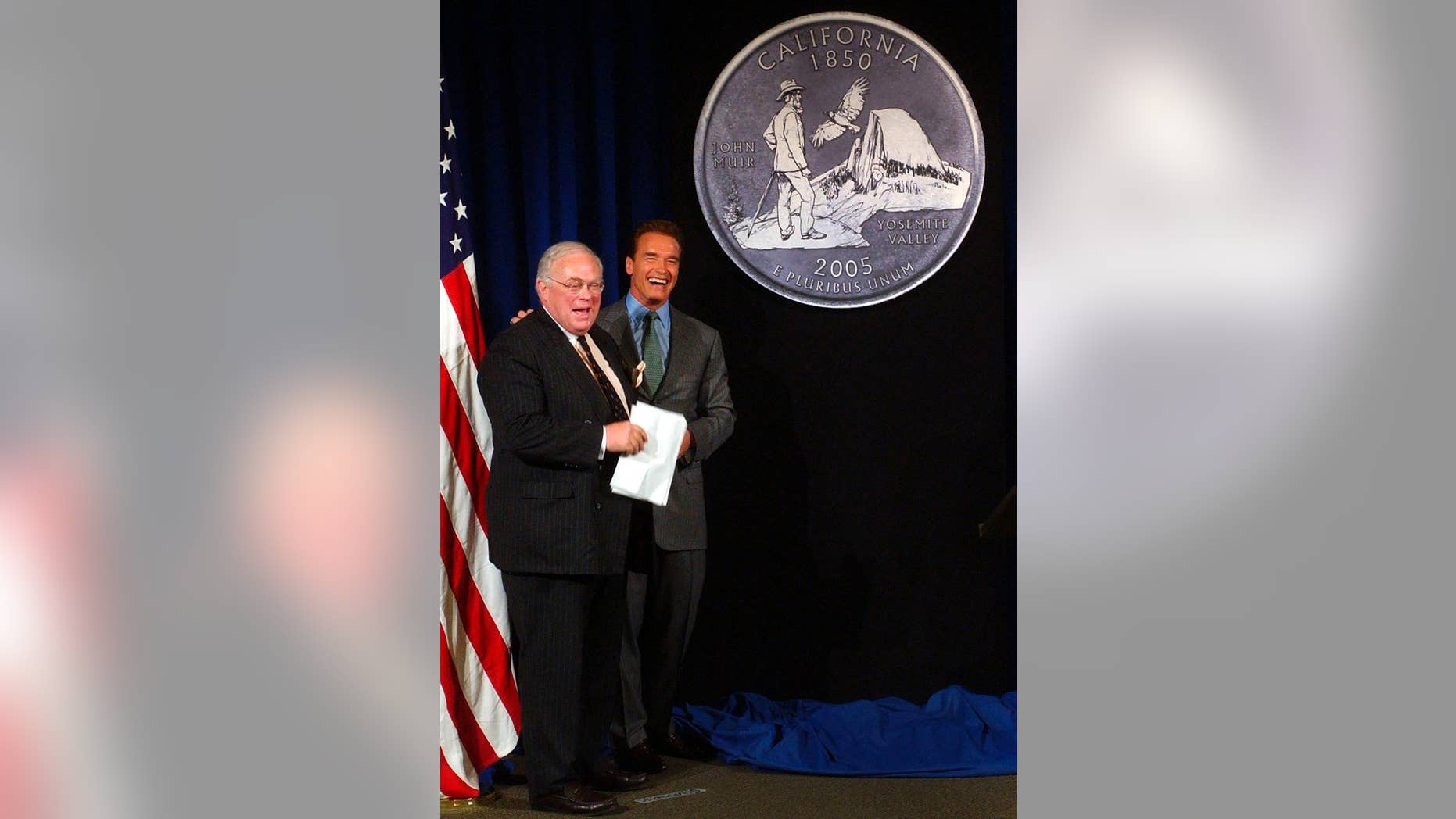FILE - In this March 29, 2004, file photo, California Gov. Arnold Schwarzenegger, right, and state Librarian Kevin Starr, smile after unveiling the design chosen for the California Quarter during ceremonies in Sacramento, Calif. Starr, California's former librarian and one of the state's premier historians, died Saturday, Jan. 14, 2017. He was 76 (AP Photo/Rich Pedroncelli, File)