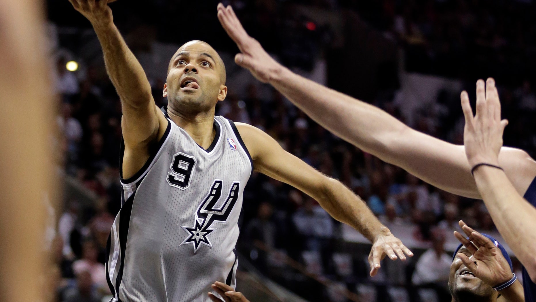 San Antonio Spurs' Tony Parker (9), of France, goes up for a shot against the Memphis Grizzlies defense during the first half in Game 2 of the Western Conference finals NBA basketball playoff series, Tuesday, May 21, 2013, in San Antonio. (AP Photo/Eric Gay)