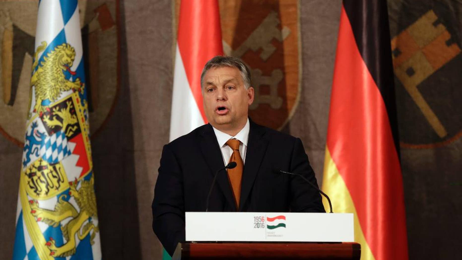 Hungary's Prime Minister Victor Orban stands on the podium during his speech to mark the 60th anniversary of the Hungarian Revolution in Munich, Germany, Monday, Oct. 17, 2016. (AP Photo/Matthias Schrader)